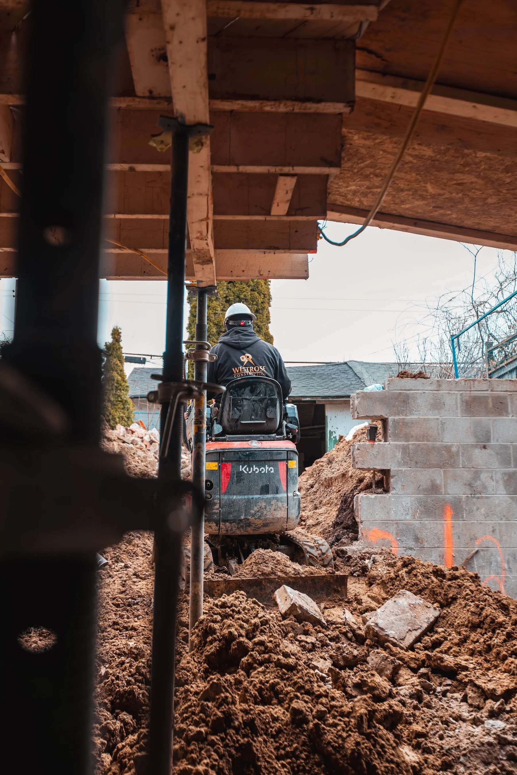 underpinning-mini-excavator-basement-digging-site.jpg