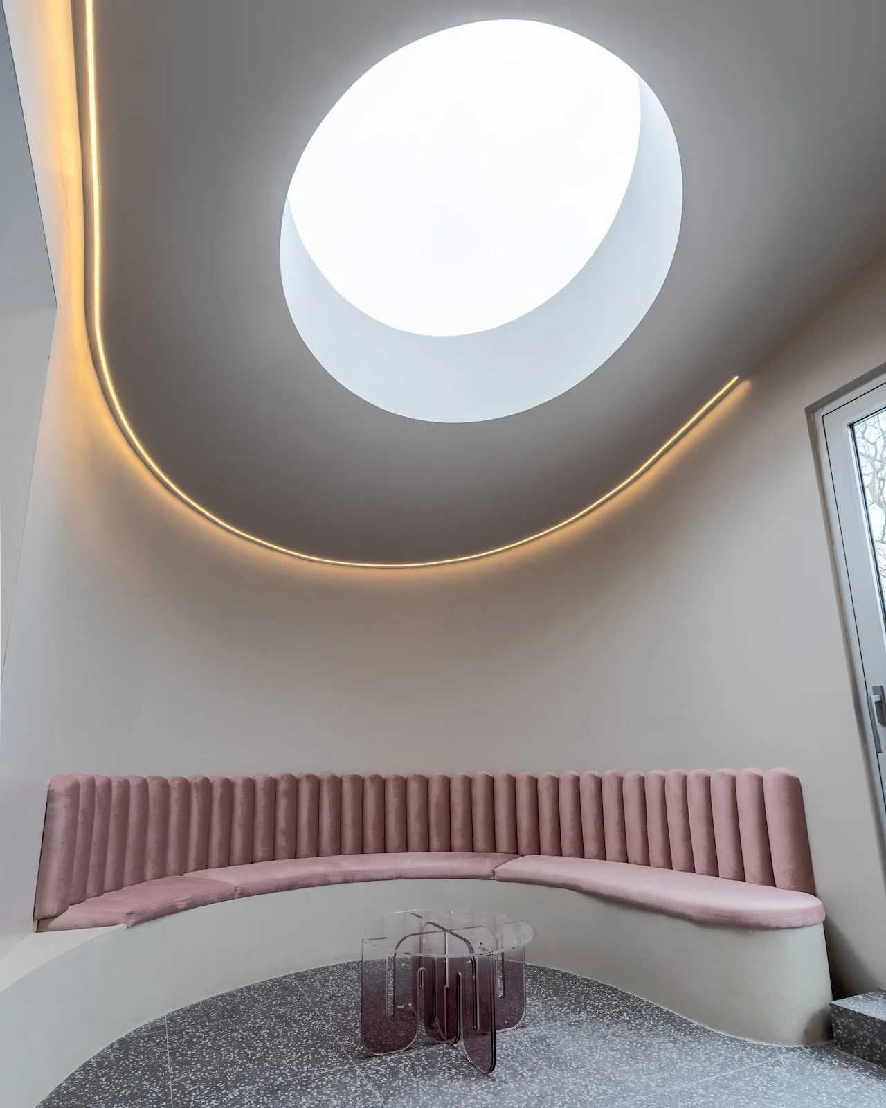 Custom circular skylight with curved built-in seating in Toronto residential home by Westrose Construction