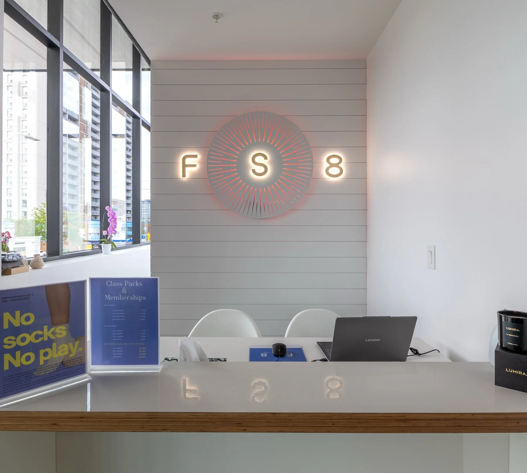 Illuminated FS8 brand signage on studio wall in Mississauga commercial fit-out