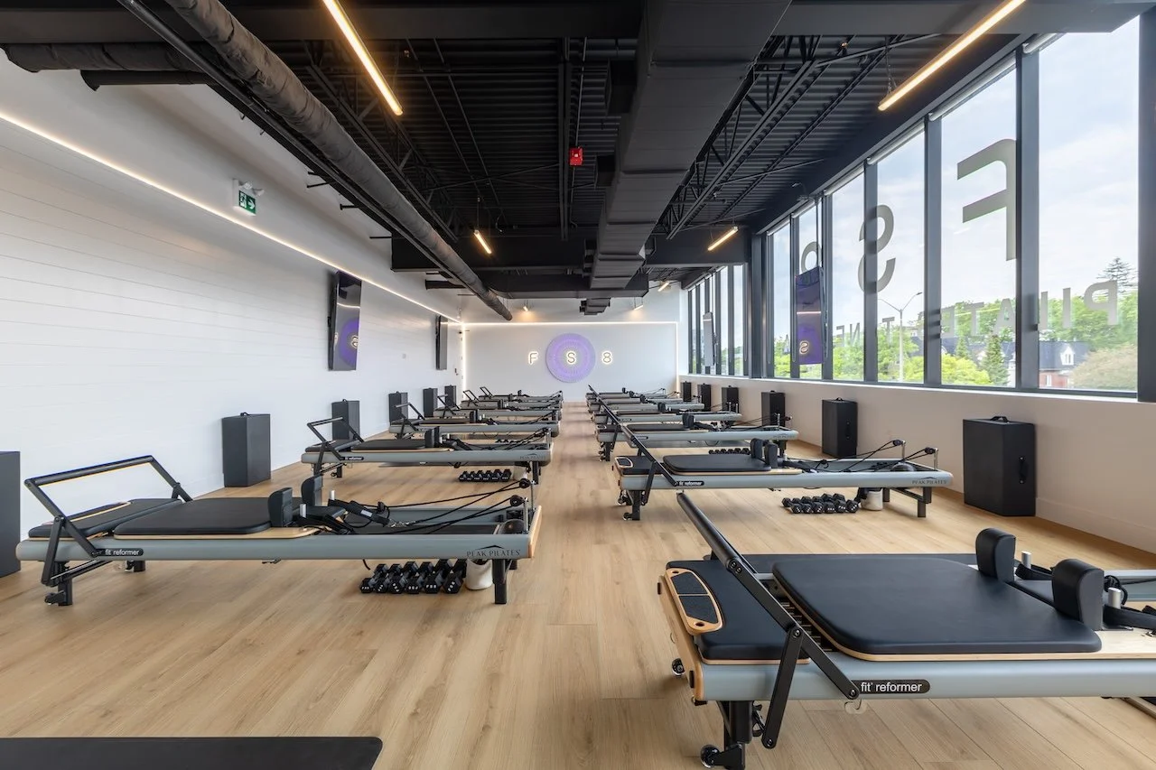 Open-concept Pilates reformer studio with natural light at FS8 Port Credit, built by Westrose Construction