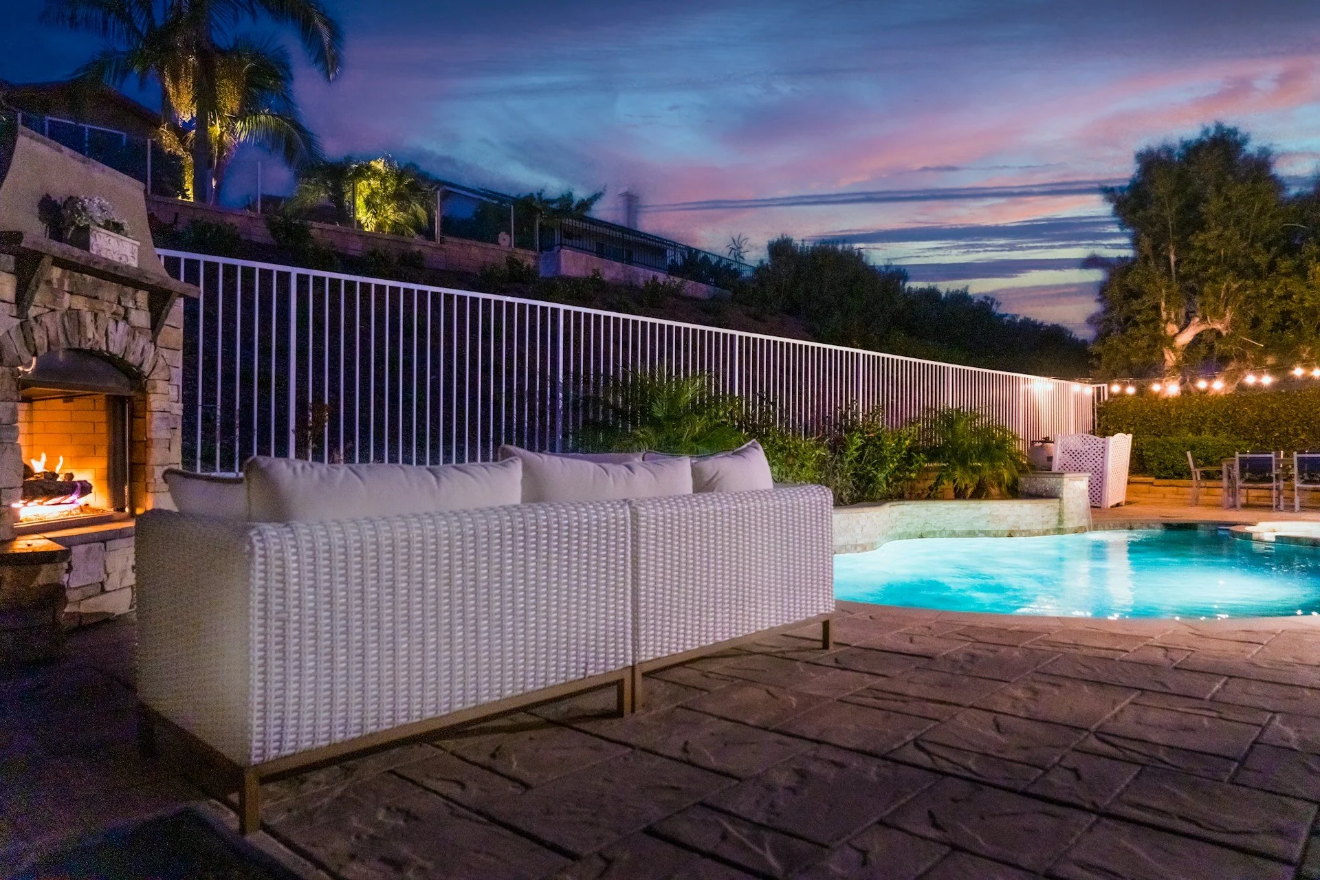 Luxury backyard patio with pool, deck and outdoor seating area showing a complete outdoor living space