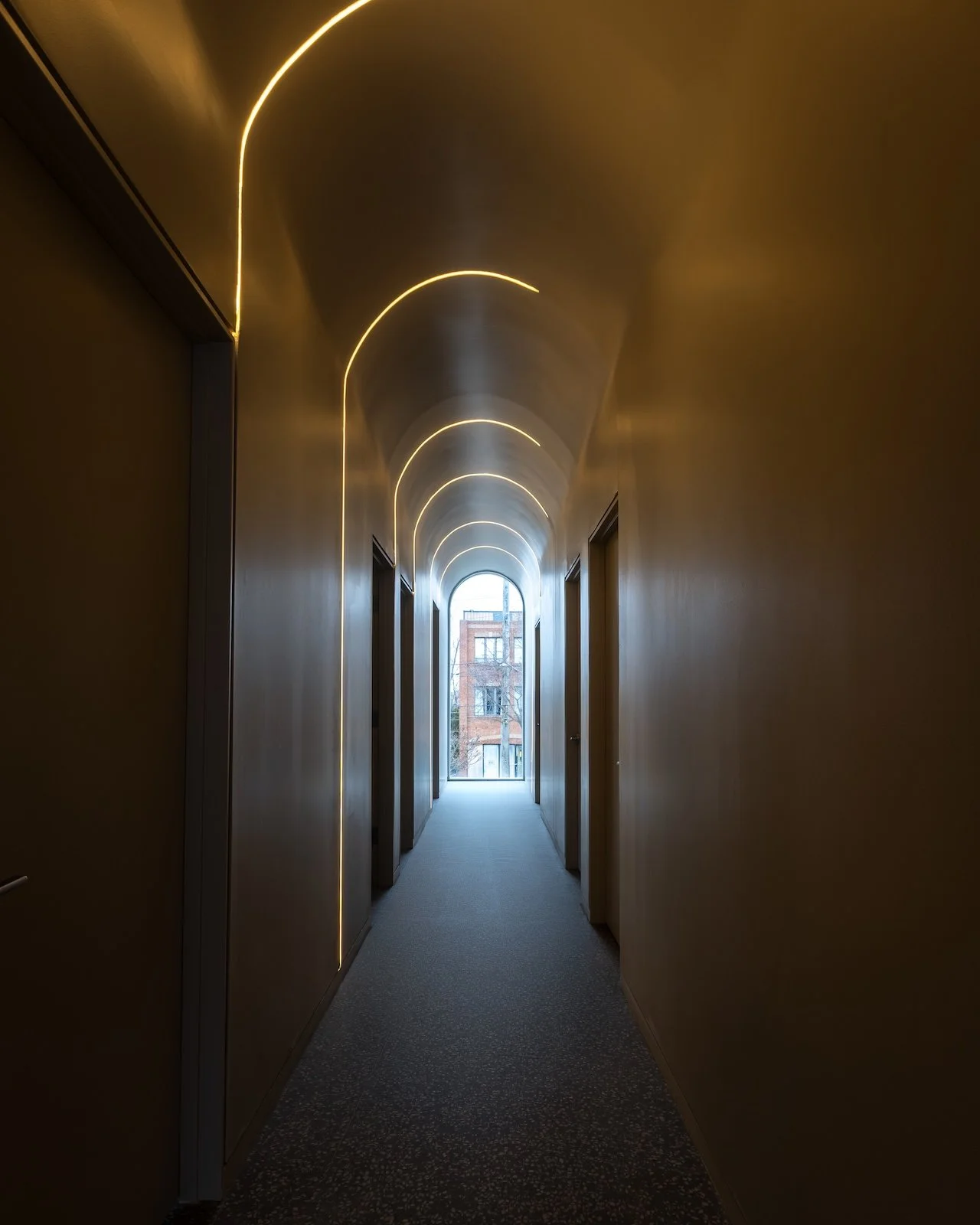 Architectural arched corridor with custom LED lighting design by Westrose Construction in Toronto commercial project