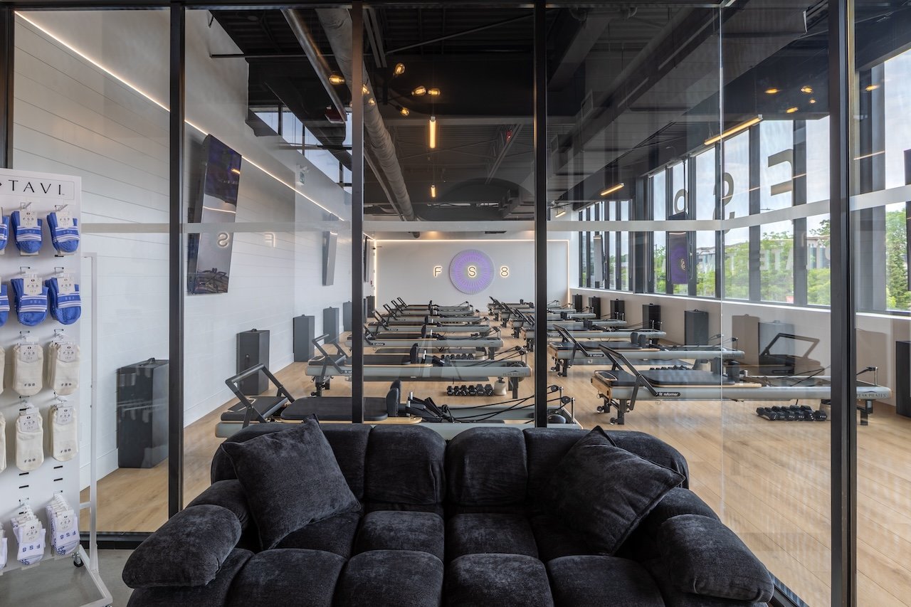 Lounge seating overlooking reformer Pilates studio at FS8 Port Credit, a Westrose Construction project