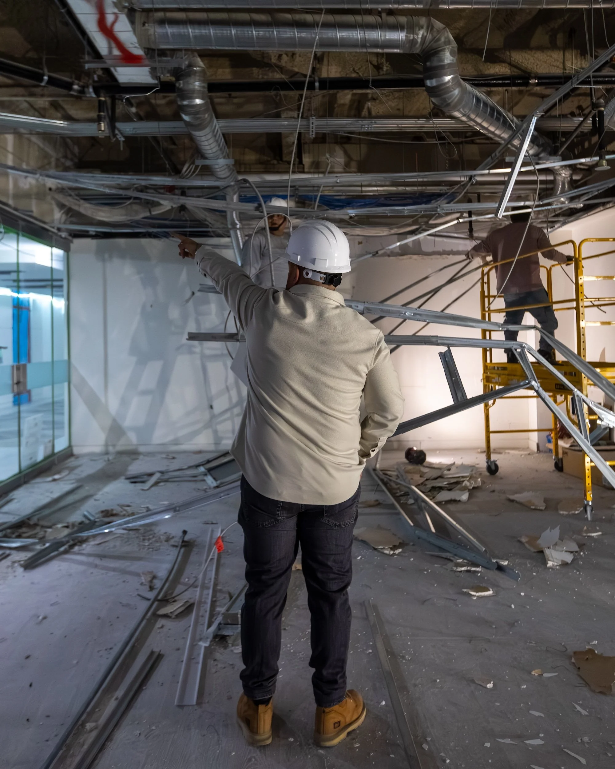 Westrose Construction owner in hard hat directing ceiling systems work during a commercial demolition and renovation project in Toronto