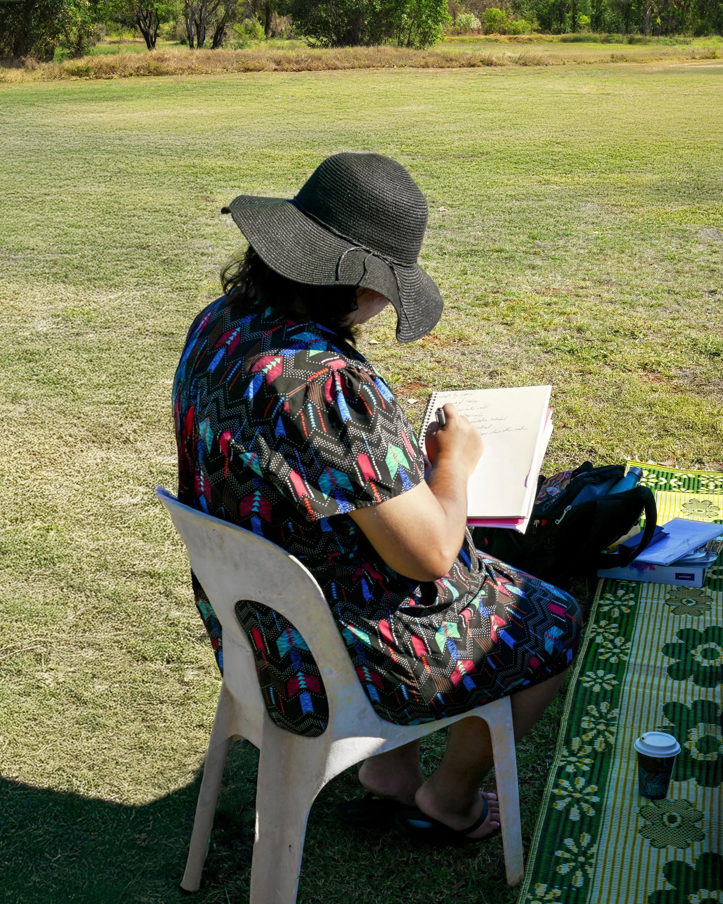 Indigenous woman taking notes at a community event.