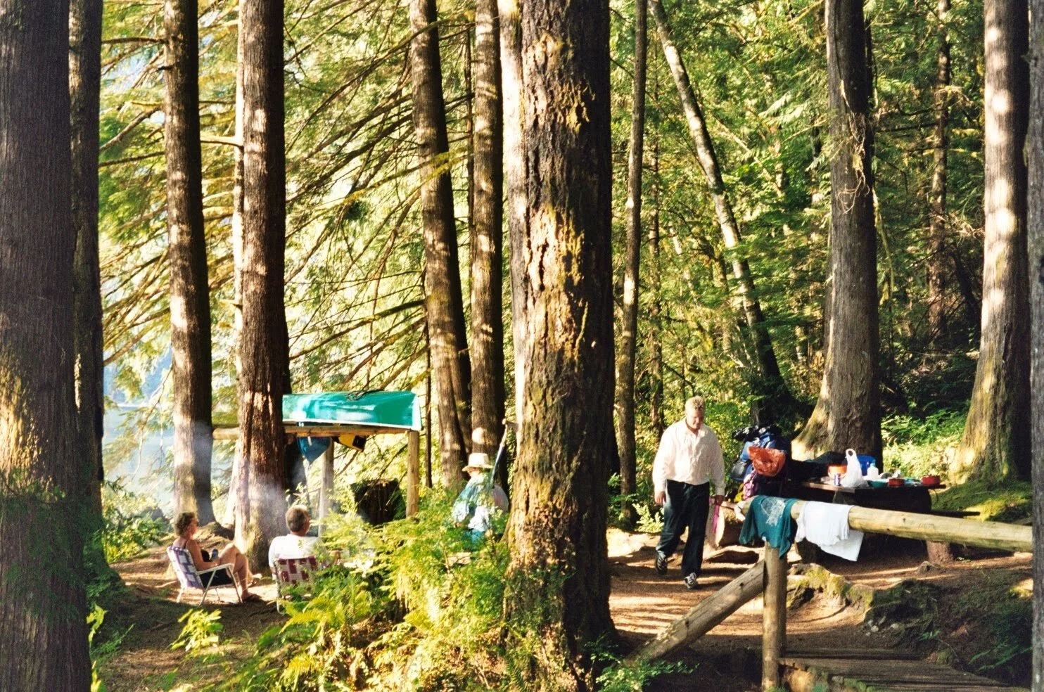 Campsite with people sitting around a fire
