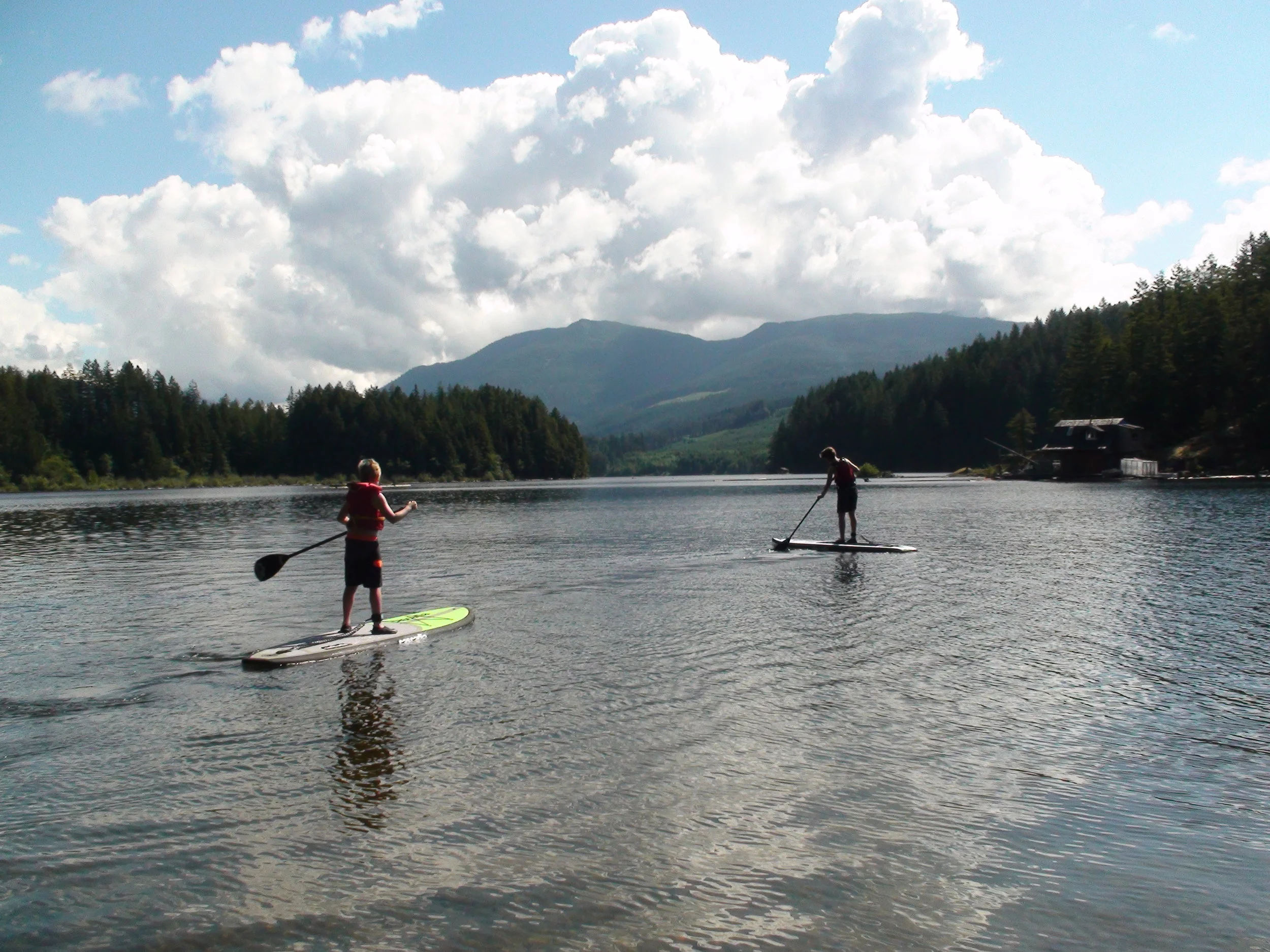 Kids Stand Up Paddle Boarding on a lake.JPG