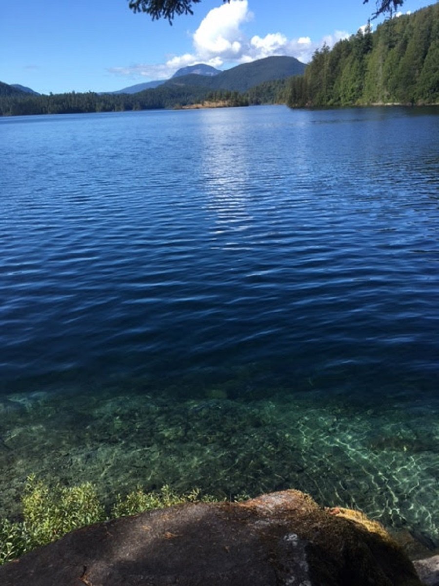 Looking from shore over a lake towards mountains