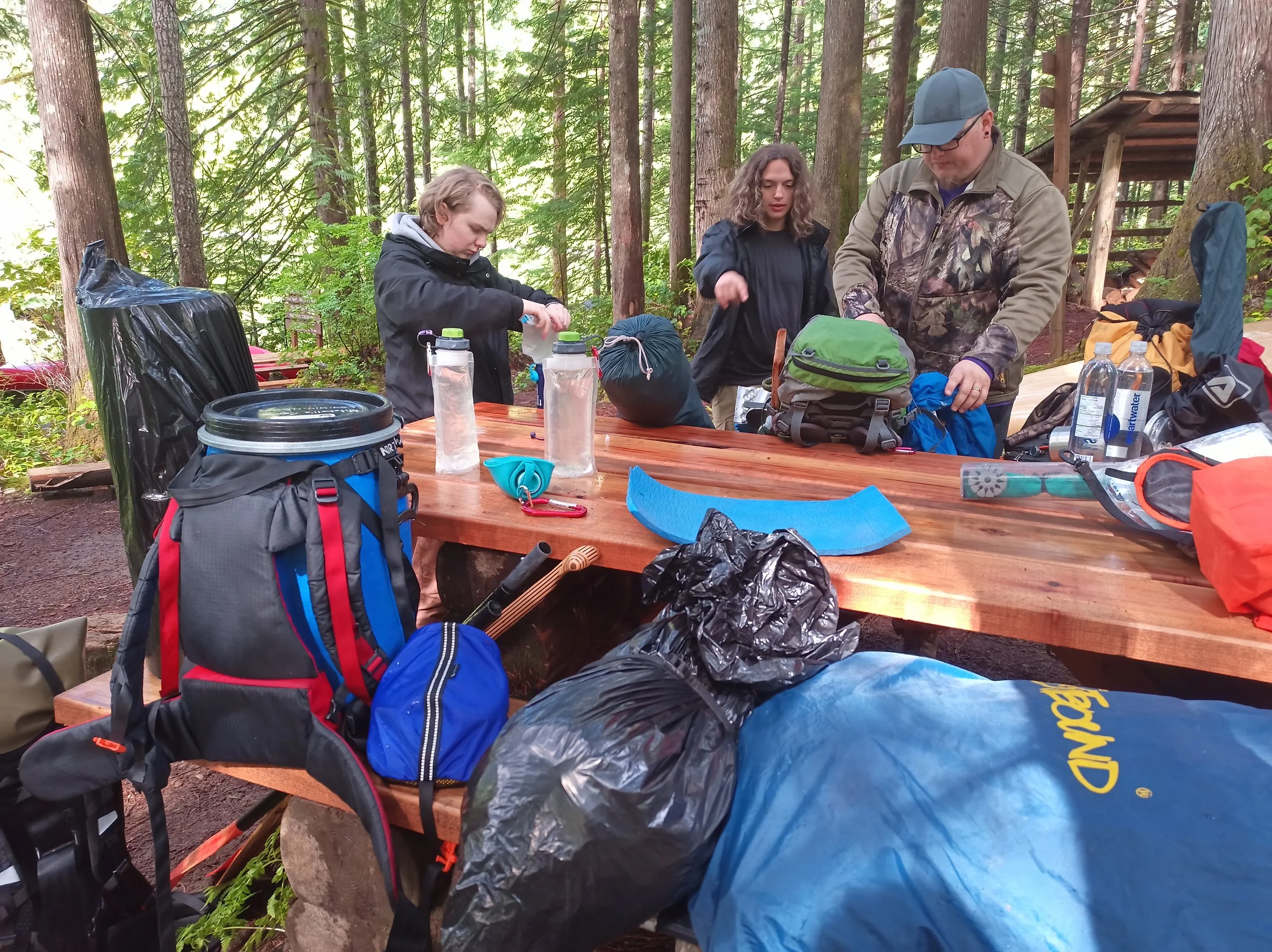 Arriving at campsite, people getting gear organized.