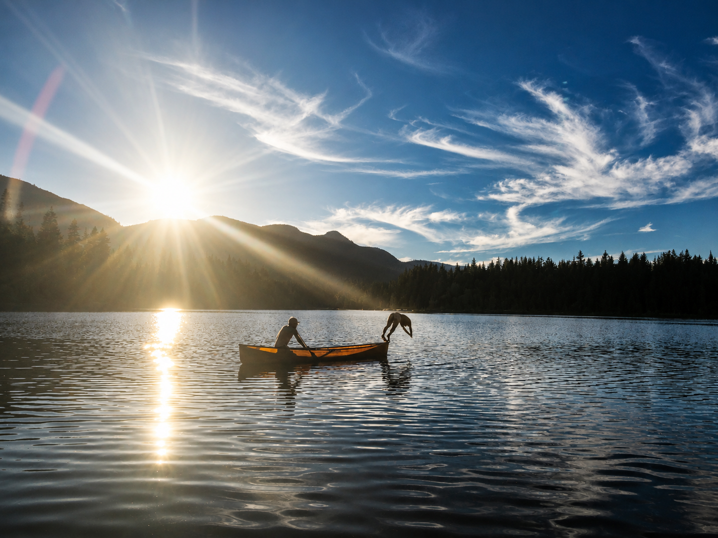Diving off a canoe at sunset on a lake