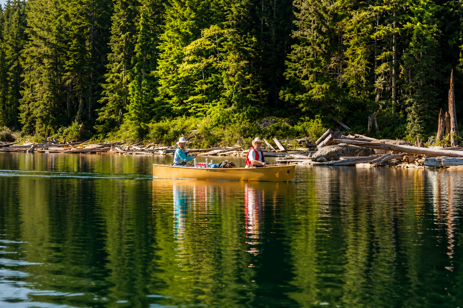 A father and son fishing from their canoe on a lake
