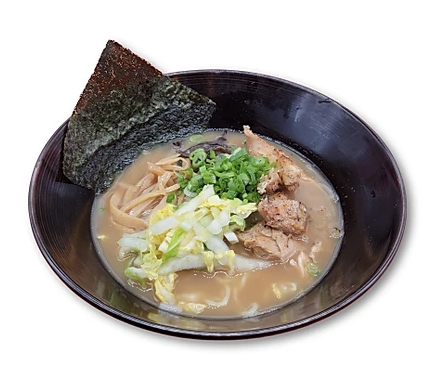 Bowl of ramen with broth, sliced meat, green onions, cabbage, seaweed, and bamboo shoots.