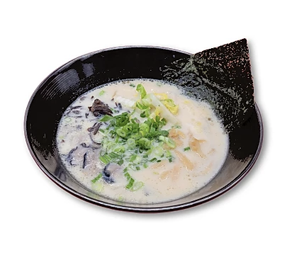 Bowl of tonkotsu ramen with green onions, mushrooms, bamboo shoots, and a sheet of seaweed.