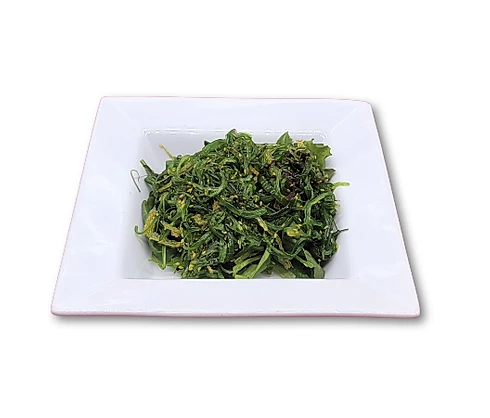 Bowl of seaweed salad on a white plate