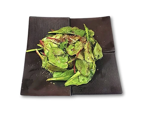 Spinach salad with pepper seasoning on a black square plate.