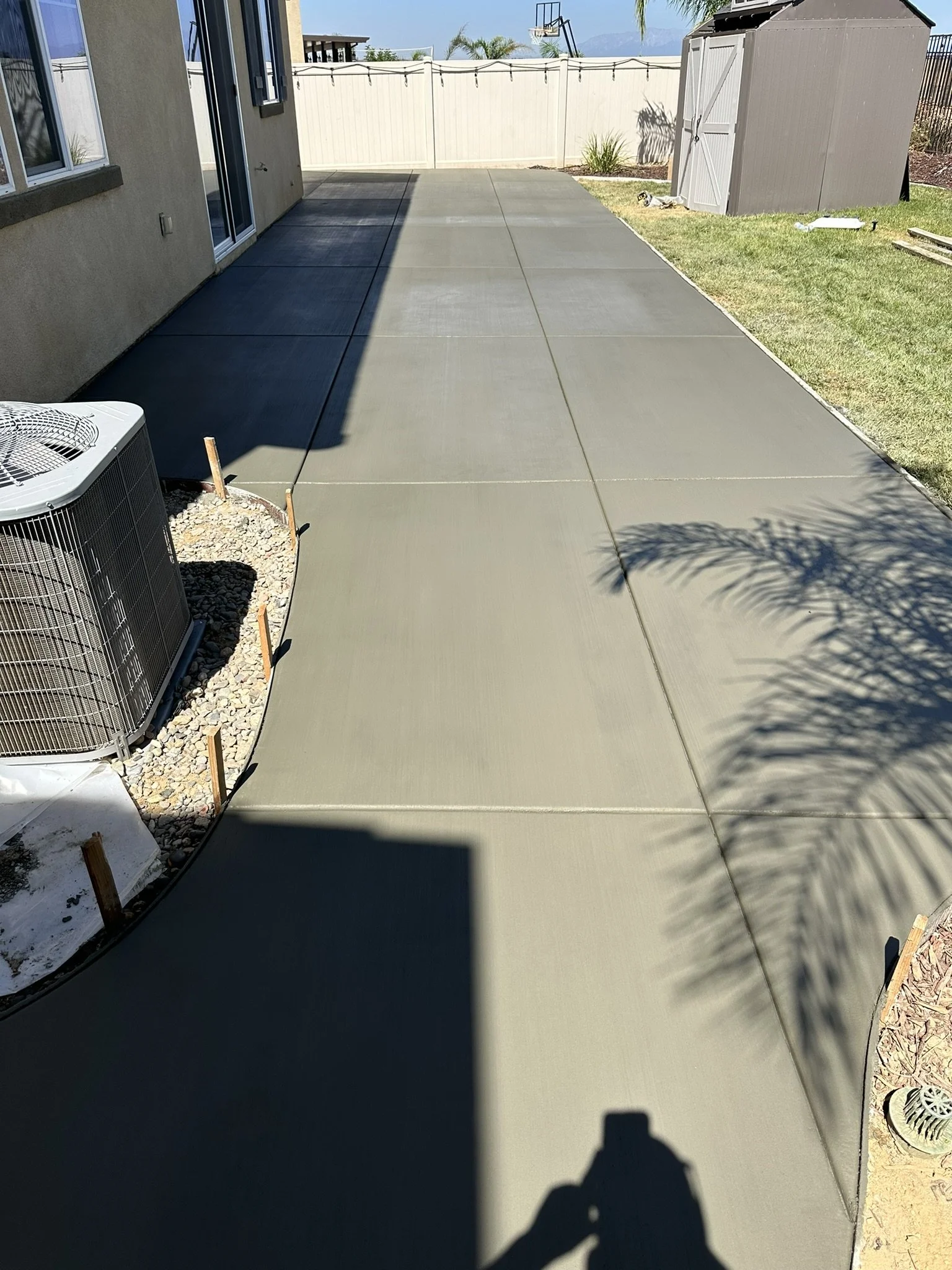 CONCRETE & FLATWORK | After the pour — newly finished concrete patio with control joints.