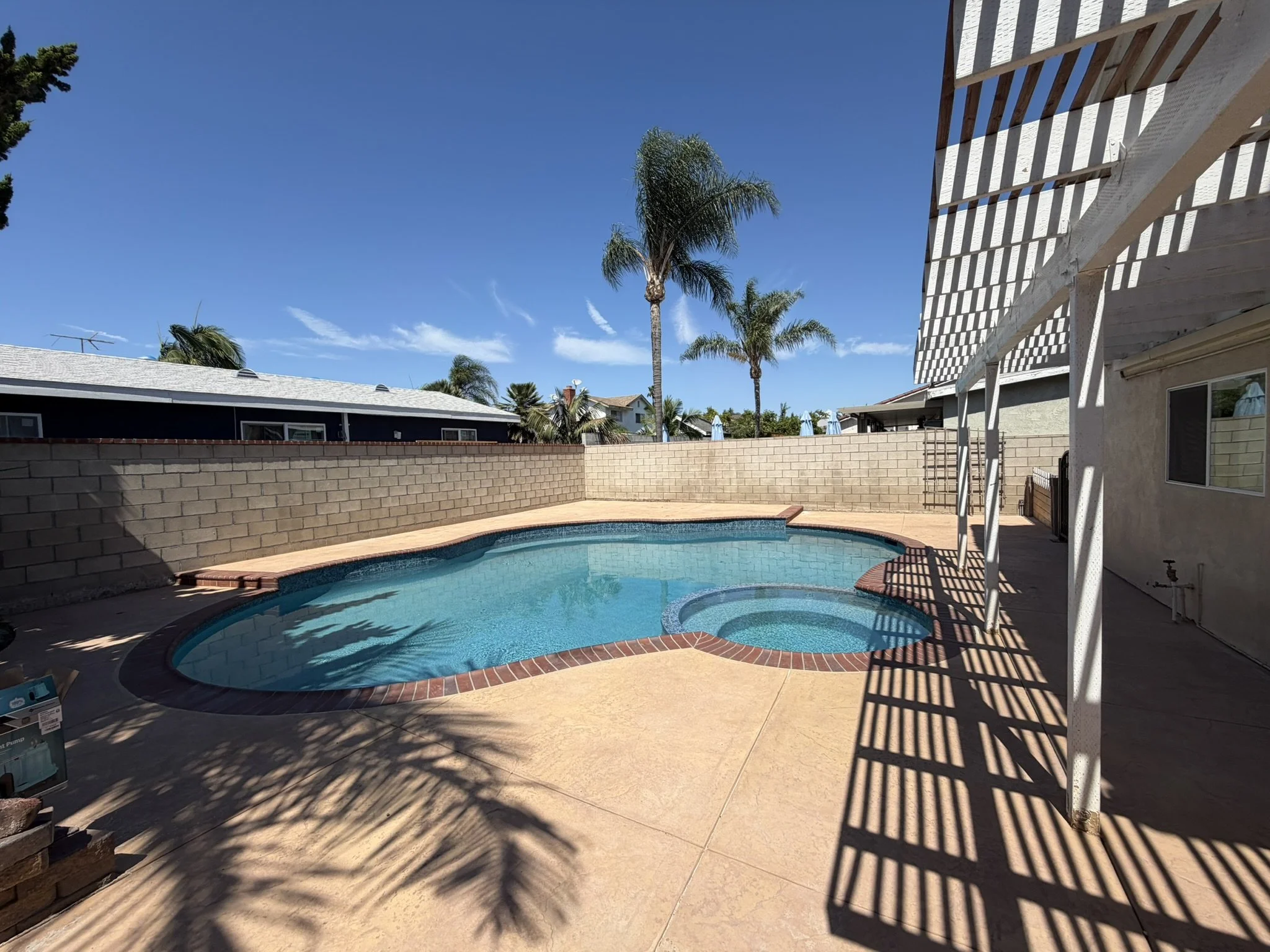 POOLS & POOLSIDE PATIOS | After — completed patio surrounding an existing pool and spa.