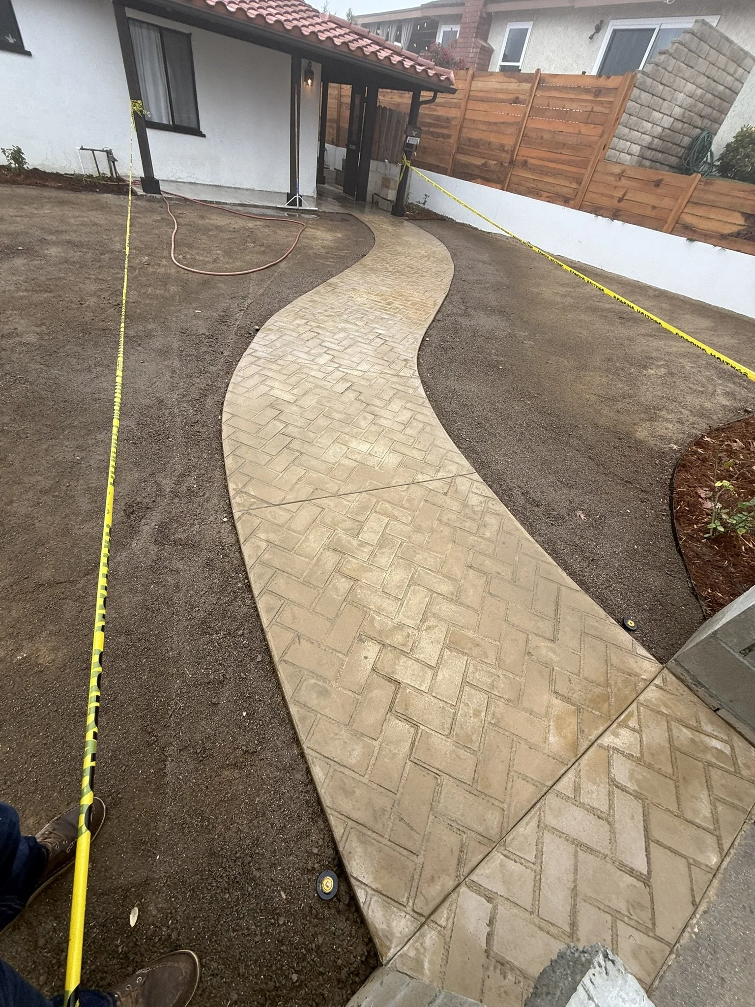 PAVERS & OUTDOOR LIVING | Curved paver walkway connecting outdoor spaces.