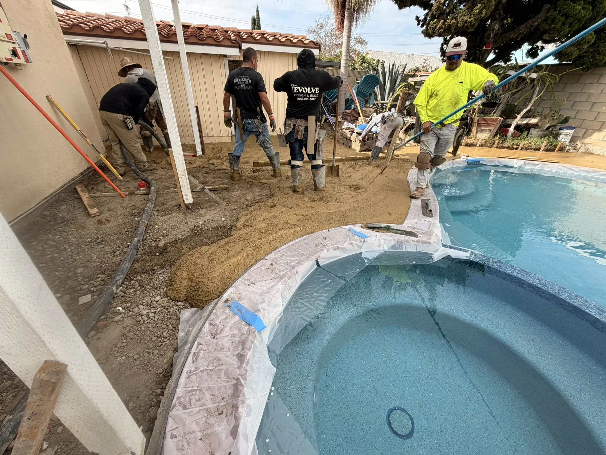 POOLS & POOLSIDE PATIOS | In progress — our crew working on the patio around the pool and spa.
