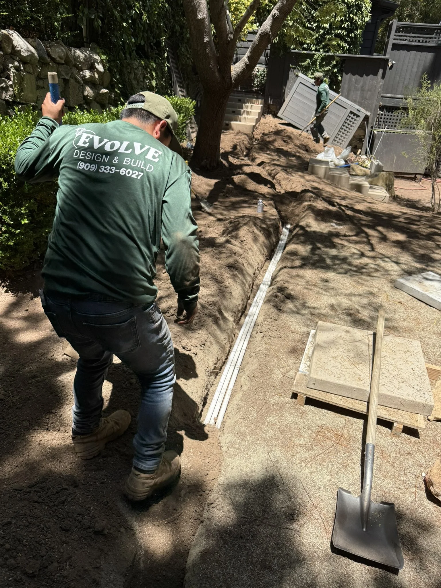 OUR CREW AT WORK | The Evolve crew at work — preparing the landscape, with our company name proudly on the shirt.