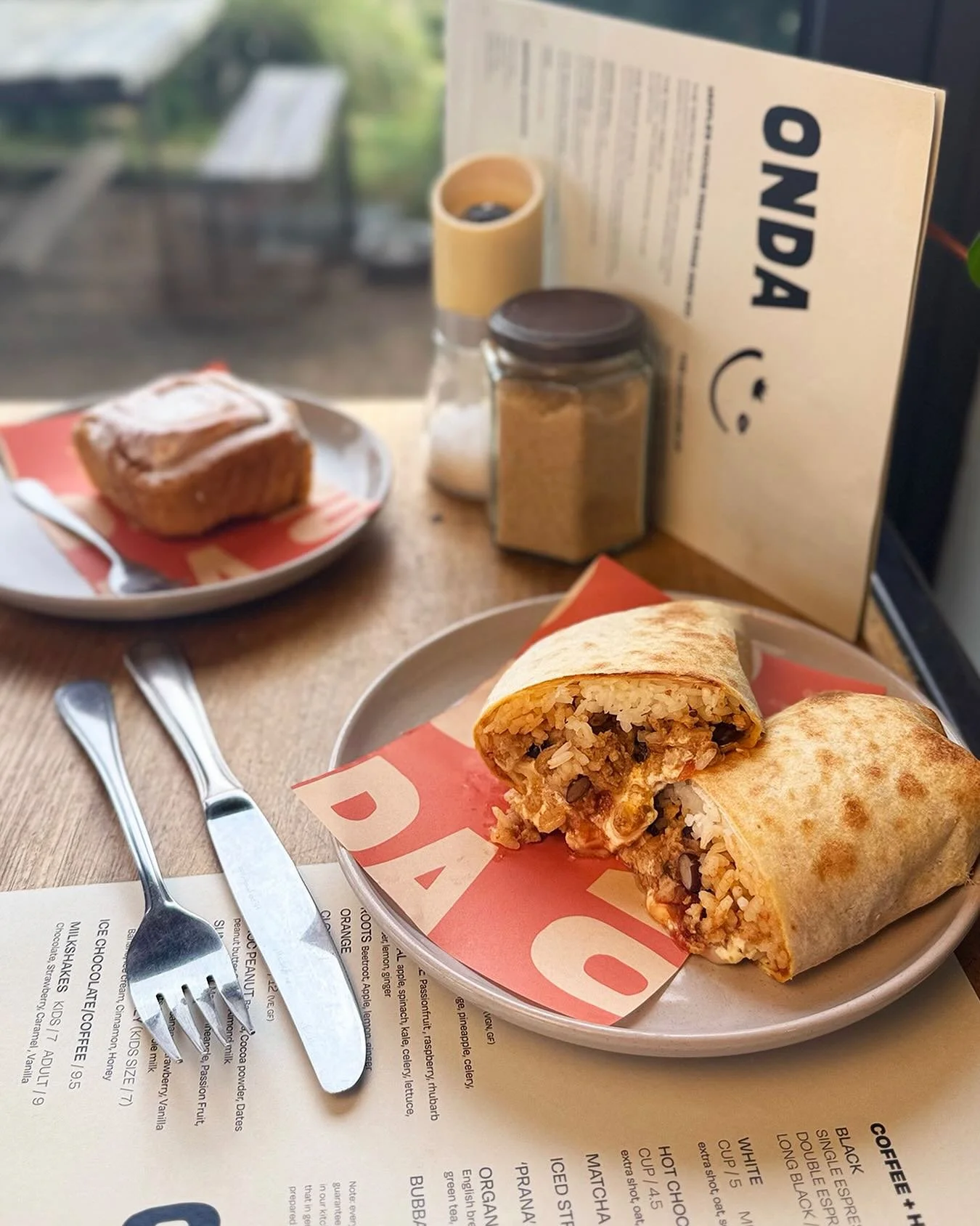 HANDHELDS READY TO GO
No time to sit down? No worries. Our wraps and jaffles are made for busy hands and full lives.

From the Otway Wrap.... a smoky, spicy vegan mix of Cajun tofu, avo, spinach and kasundi... to bacon rolls and melty jaffles stacked