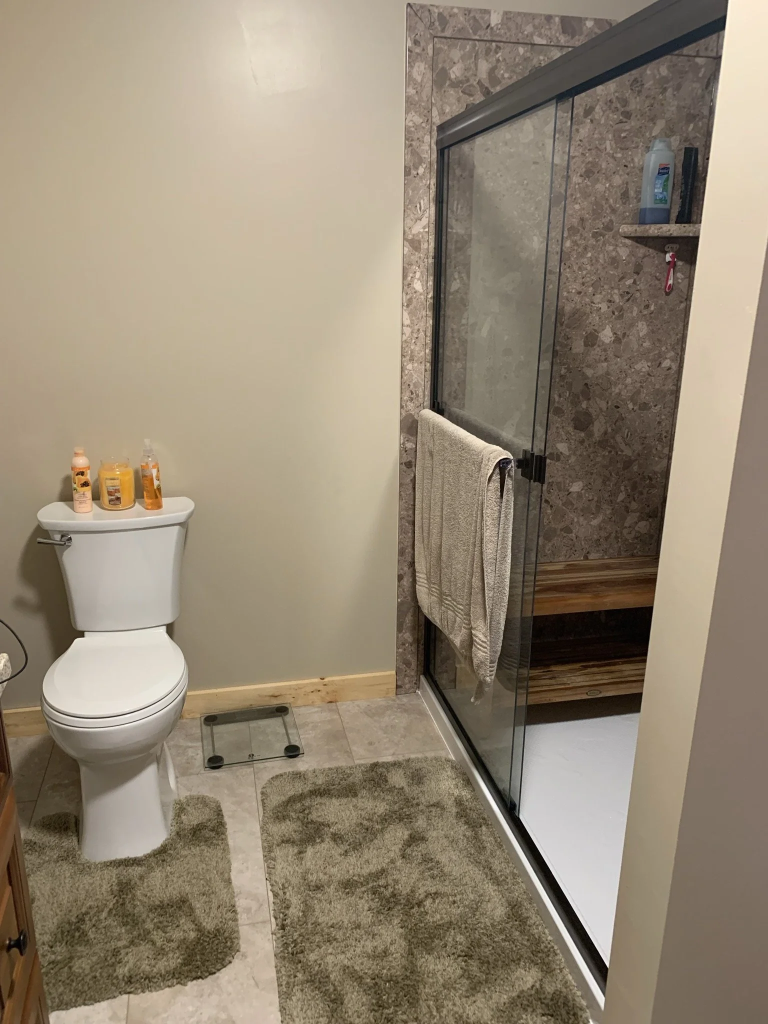 Bathroom after remodeling with an older shower enclosure, toilet, and flooring in Irwin, PA