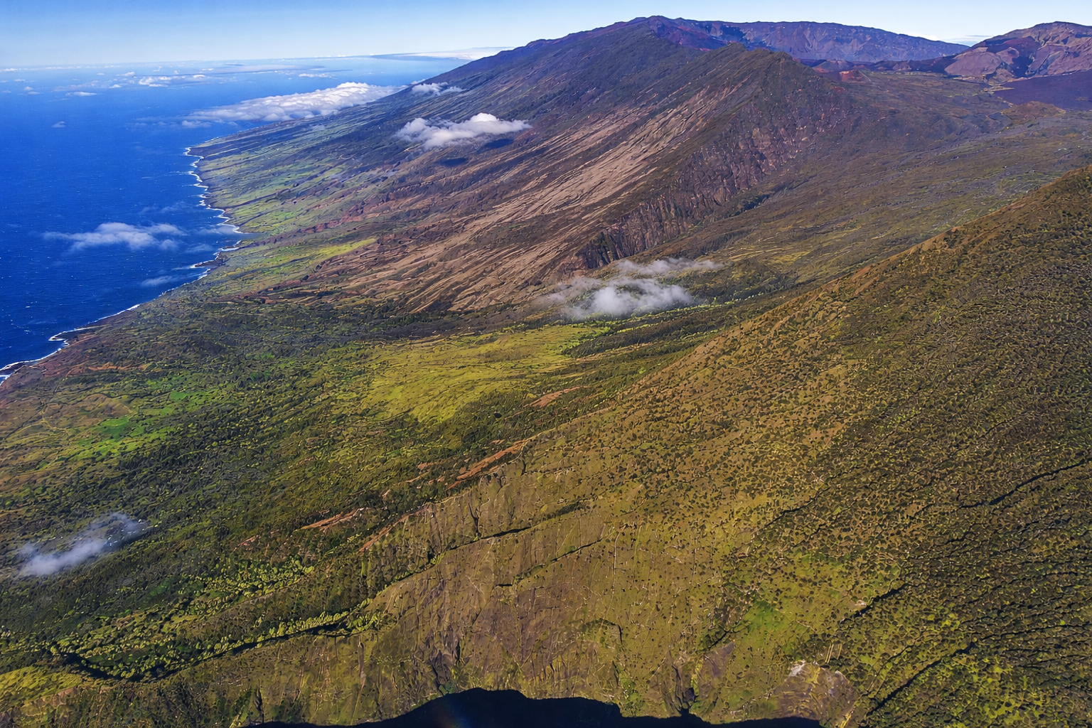 Upcountry Maui landscape with rolling hills, farmland, and distant ocean views