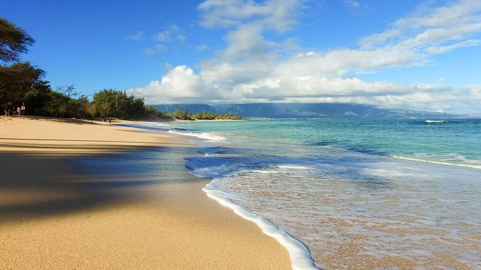 Pristine Maui beach with calm waters perfect for snorkeling and relaxation
