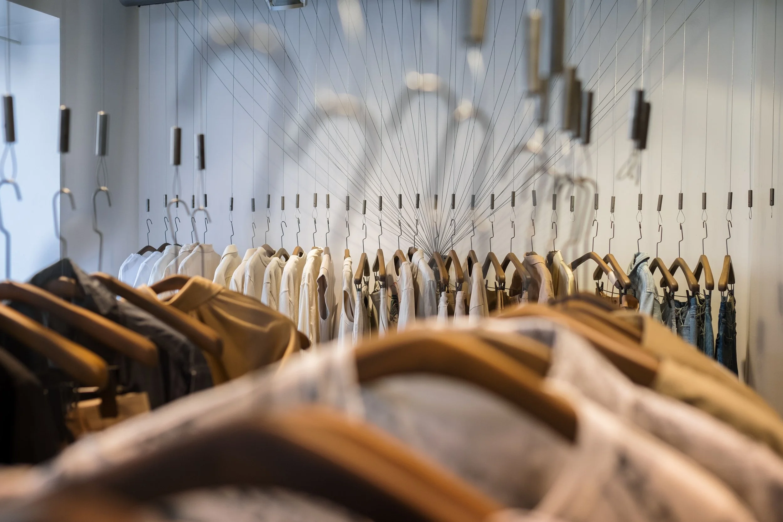 Close-up of clothing merchandised on a retail rack.