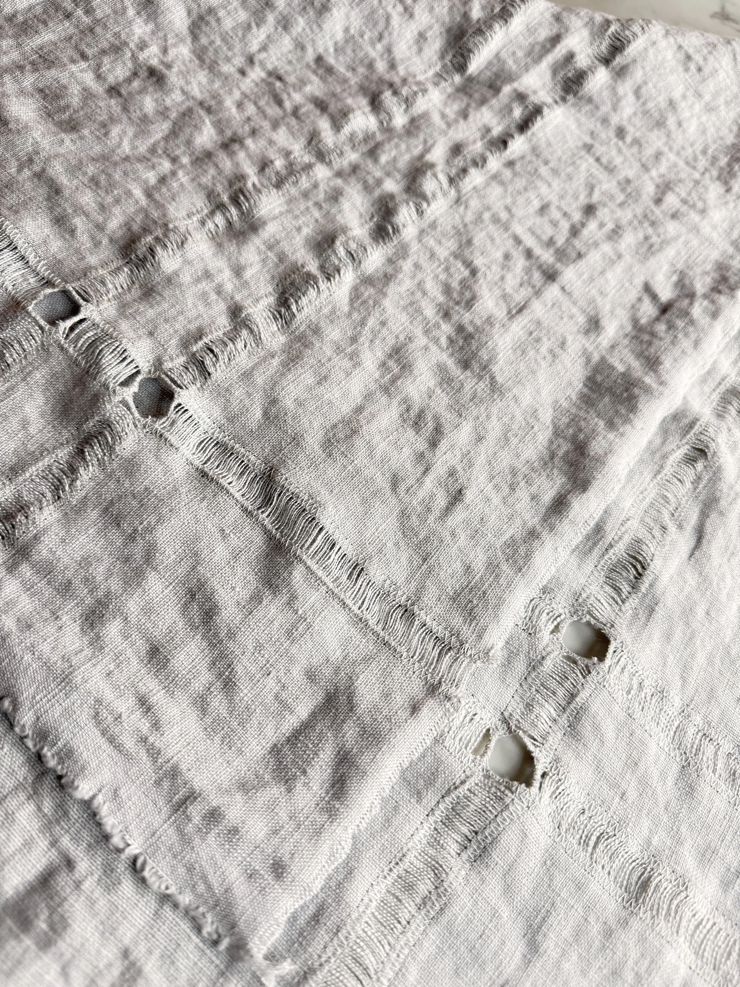 Close detail of hand-pulled hemstitch on Pearl Gray European linen napkin