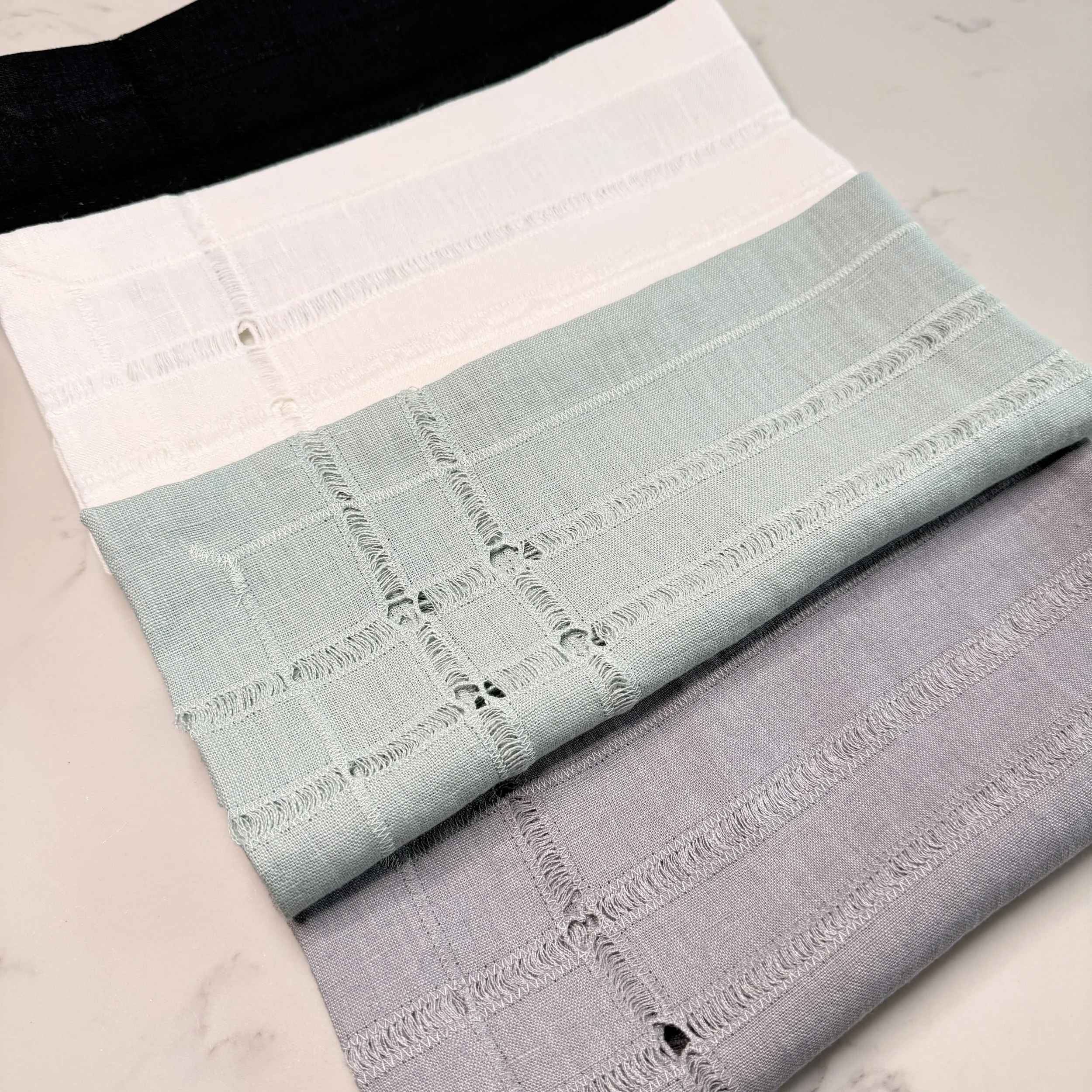 Optical White, Summer Breeze, and Gray Pearl linen napkins