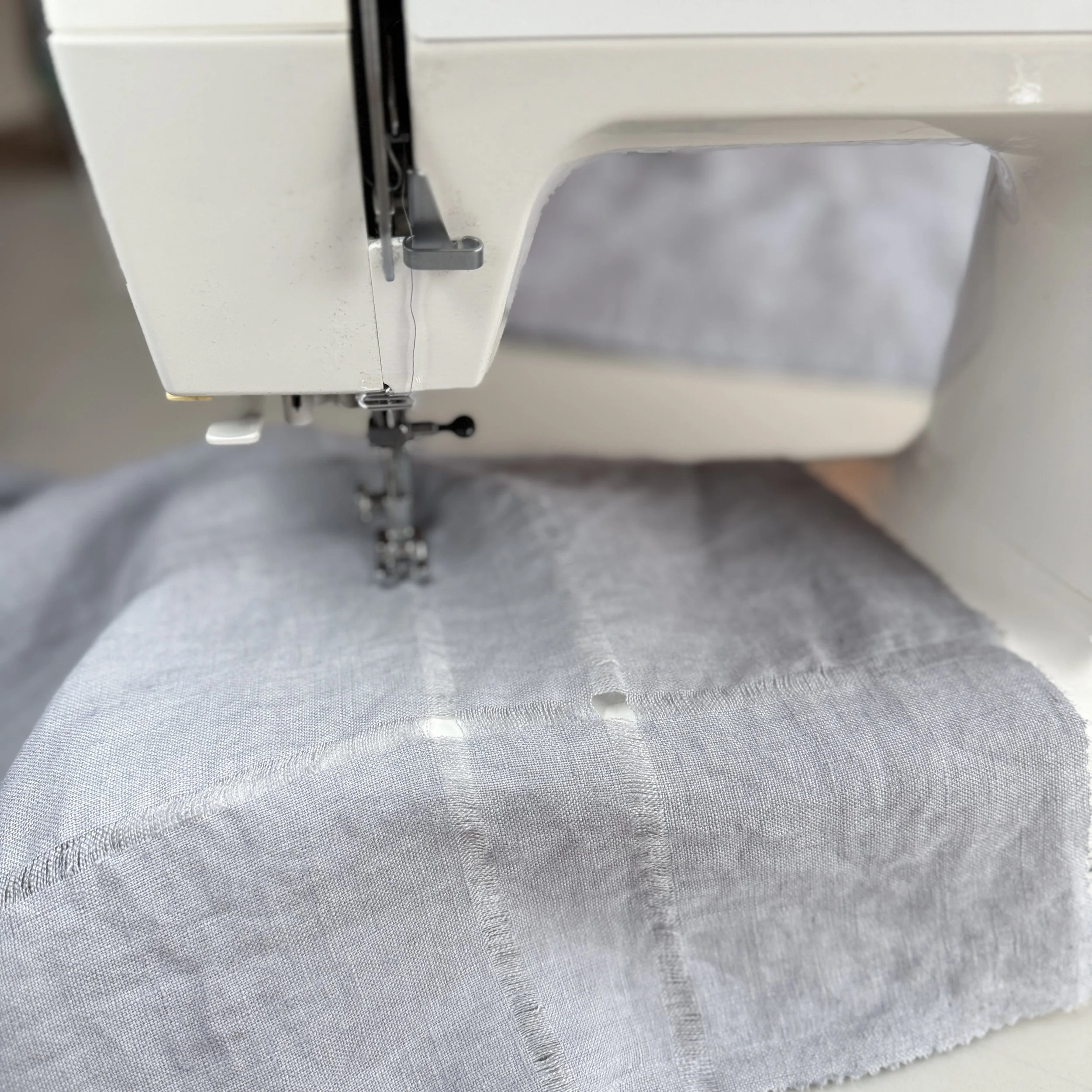 Gray Pearl Linen hems are finished on a studio sewing machine