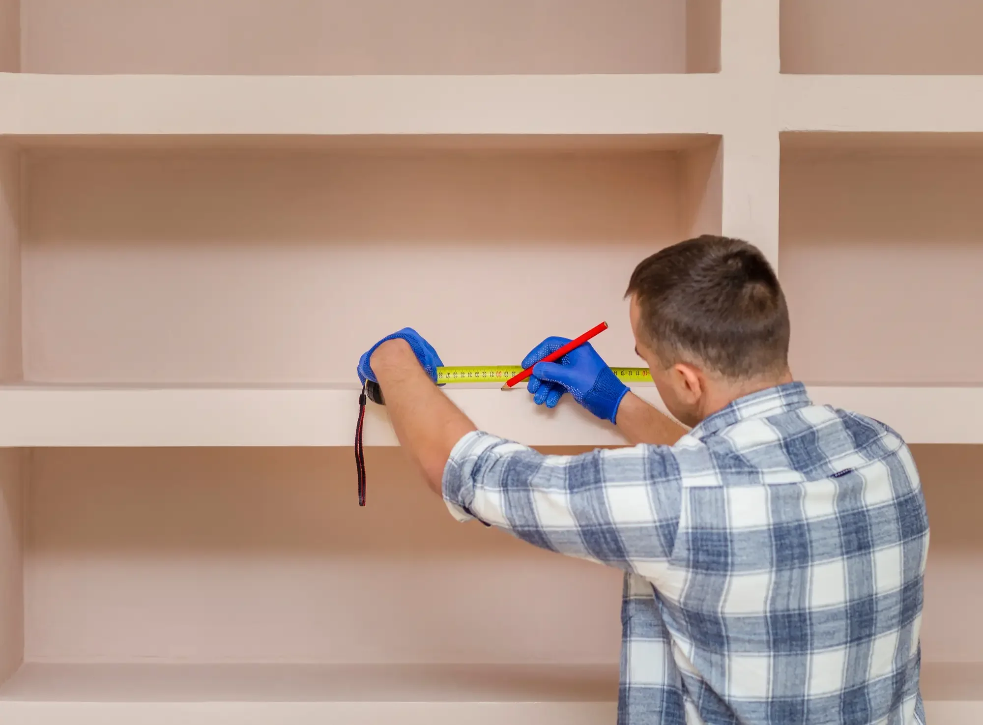 a carpenter working on a cupboard
