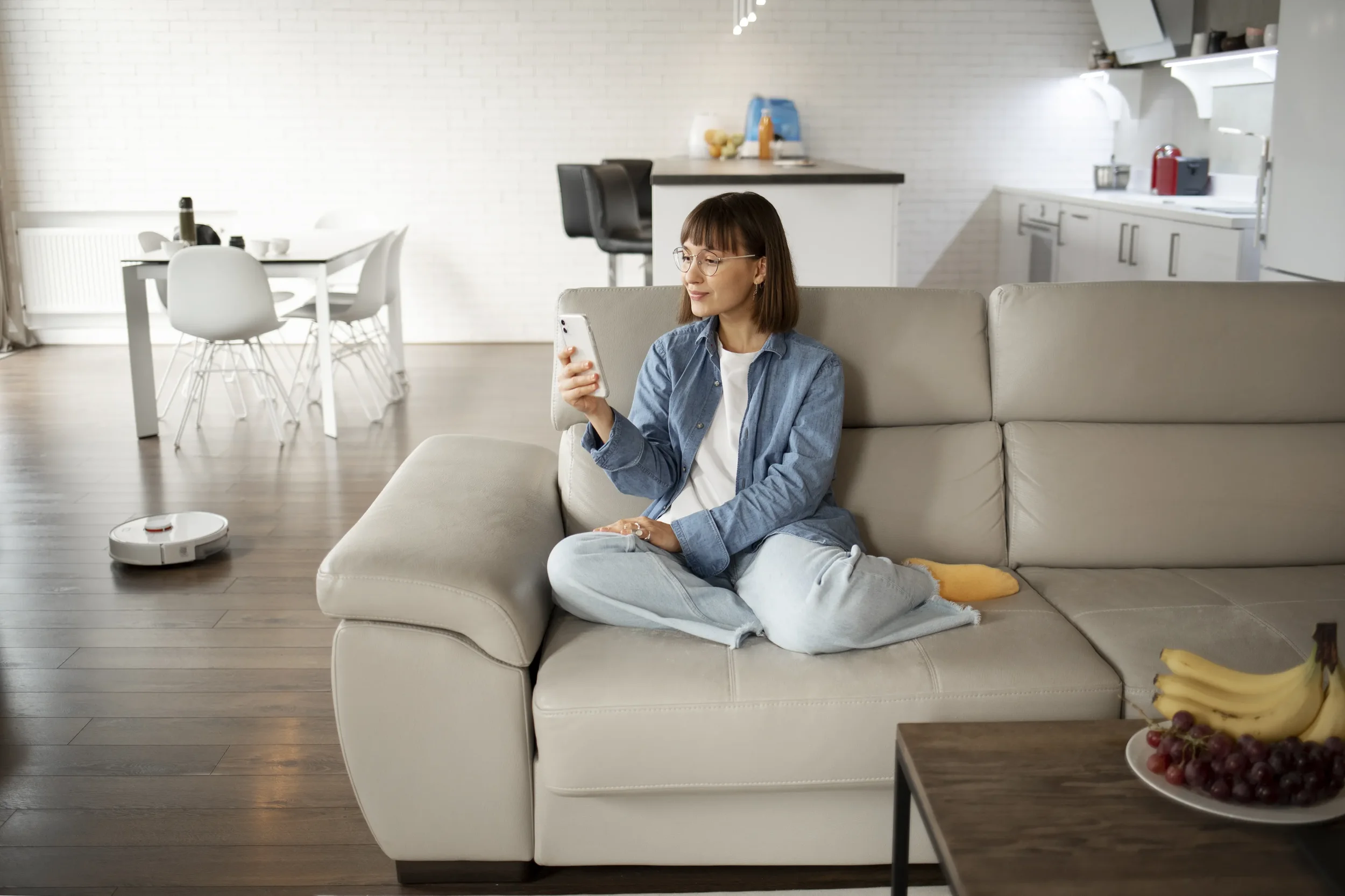 A young women using a smartphone to control smart home devices