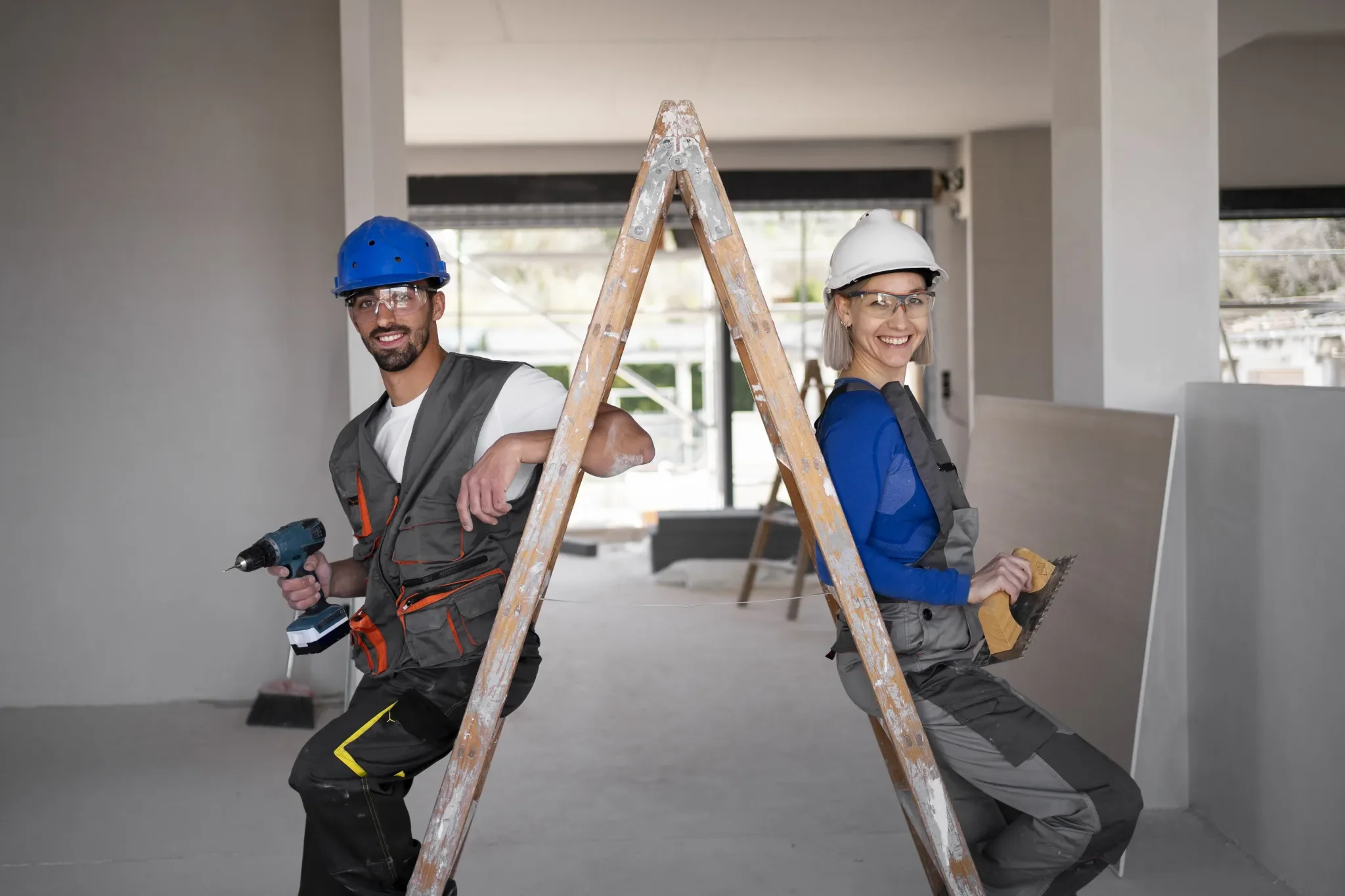 A Man and a women, working at a construction  site.