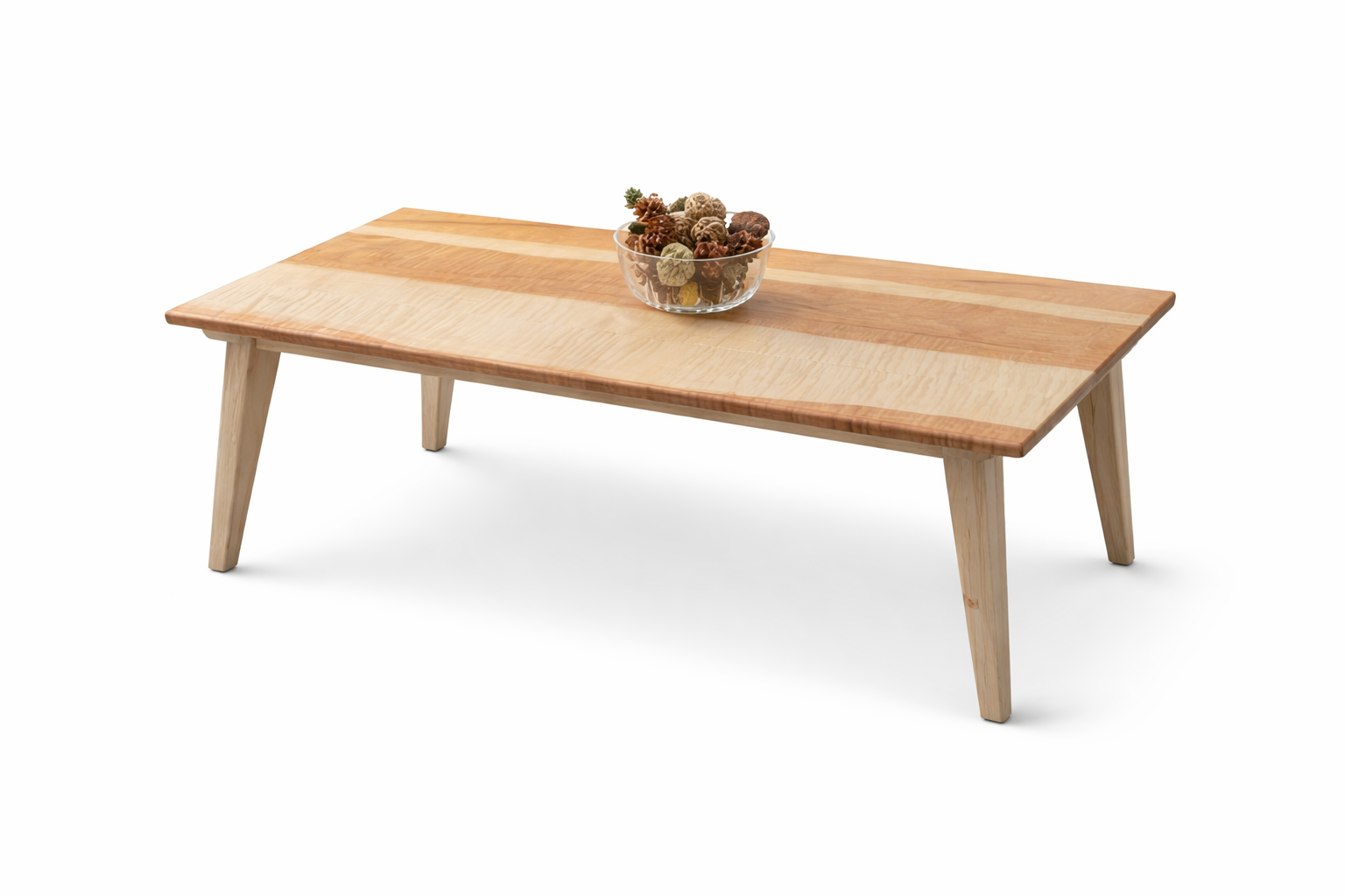 Wooden coffee table with a glass bowl of pinecones in the center.
