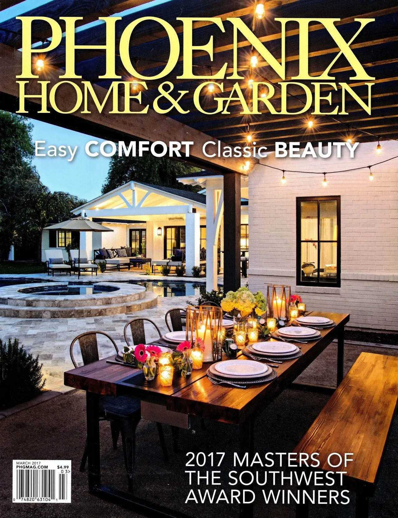 Phoenix Home & Garden magazine cover featuring a decorated outdoor dining area with a wooden table set with plates and flowers, under string lights, near a modern house with a patio and pool.