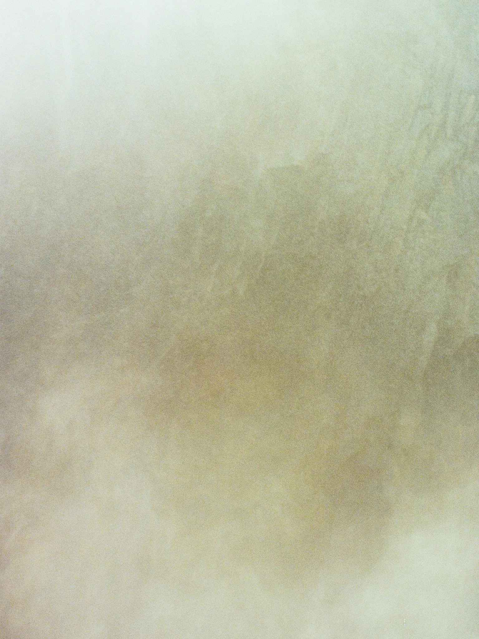 A plain, textured surface with a gradient of soft colors ranging from light beige to off-white.