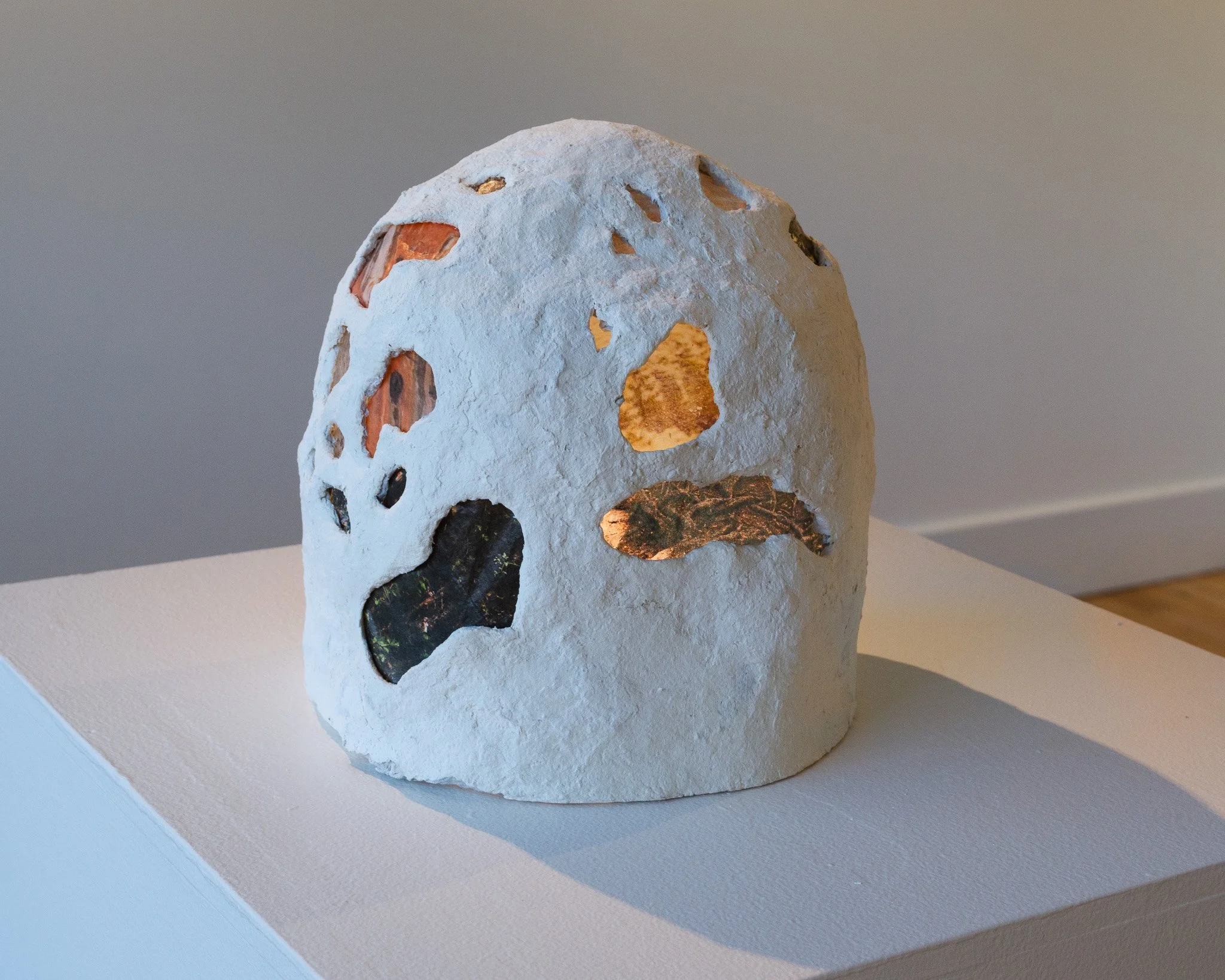 Tracings Portal, 2025. Paper pulp clay, rice paper, photo transfer, light; 7.5”x7”diameter.