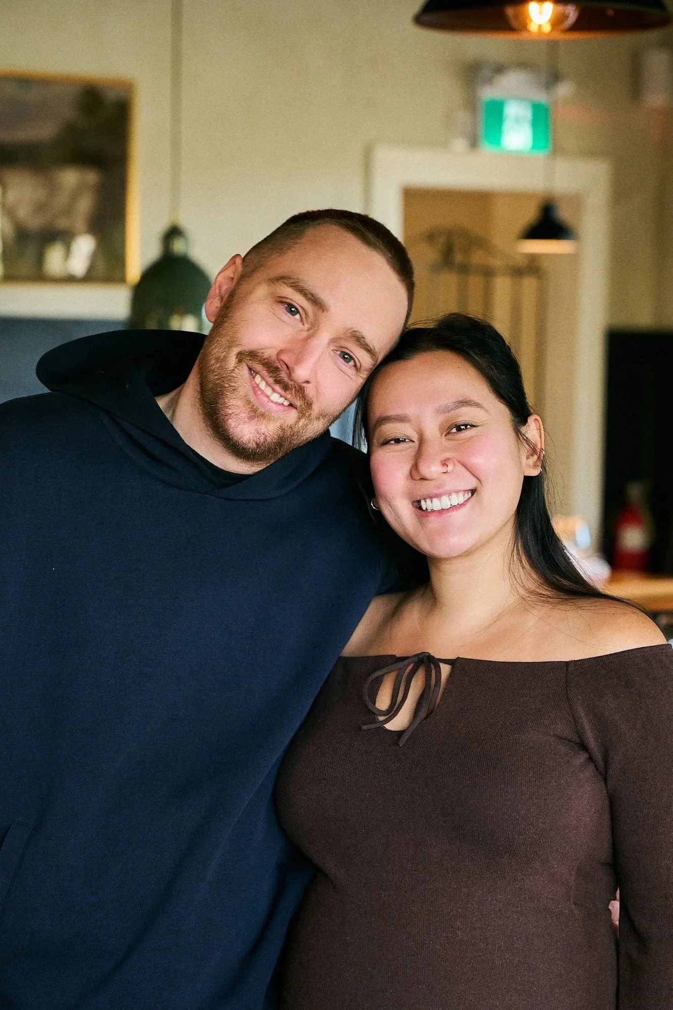 Jenn Nguyen and Mike Robertson stand beside the bar in the pub at MacTaverne.  Chef and patiserrie chef who make classic dishes like scotch eggs, steaks and sticky toffee puddings in their family boutique inn and restaurant. 