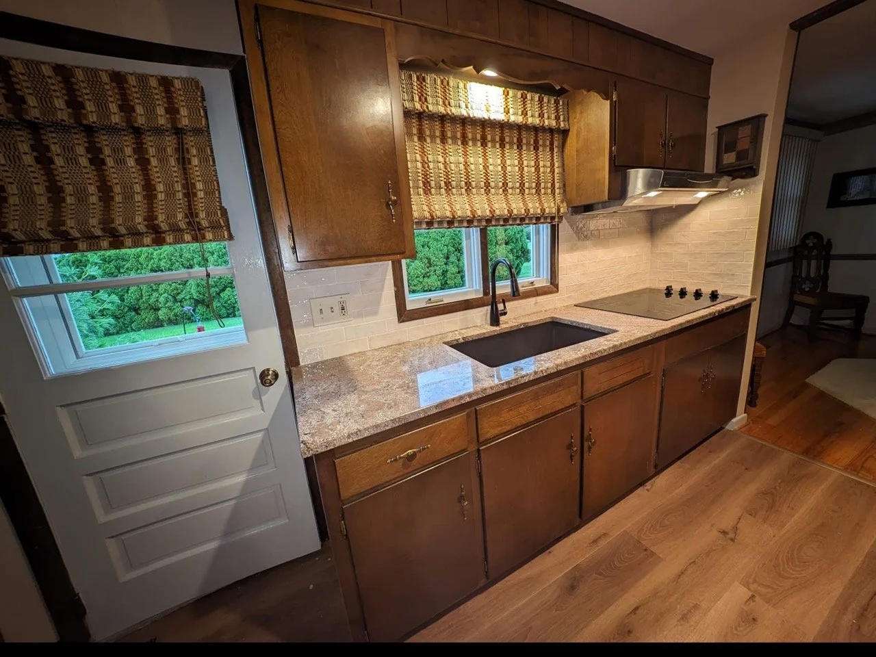Updated Easton kitchen with refinished cabinets, new backsplash, and modern counters by Mr. Handyman.
