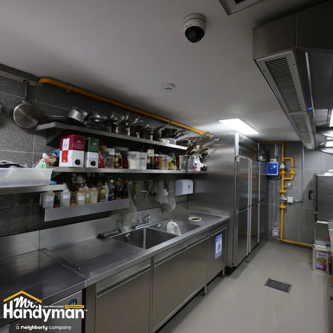 Commercial kitchen with stainless steel equipment and workstations, professional maintenance by Mr. Handyman of Lehigh Valley