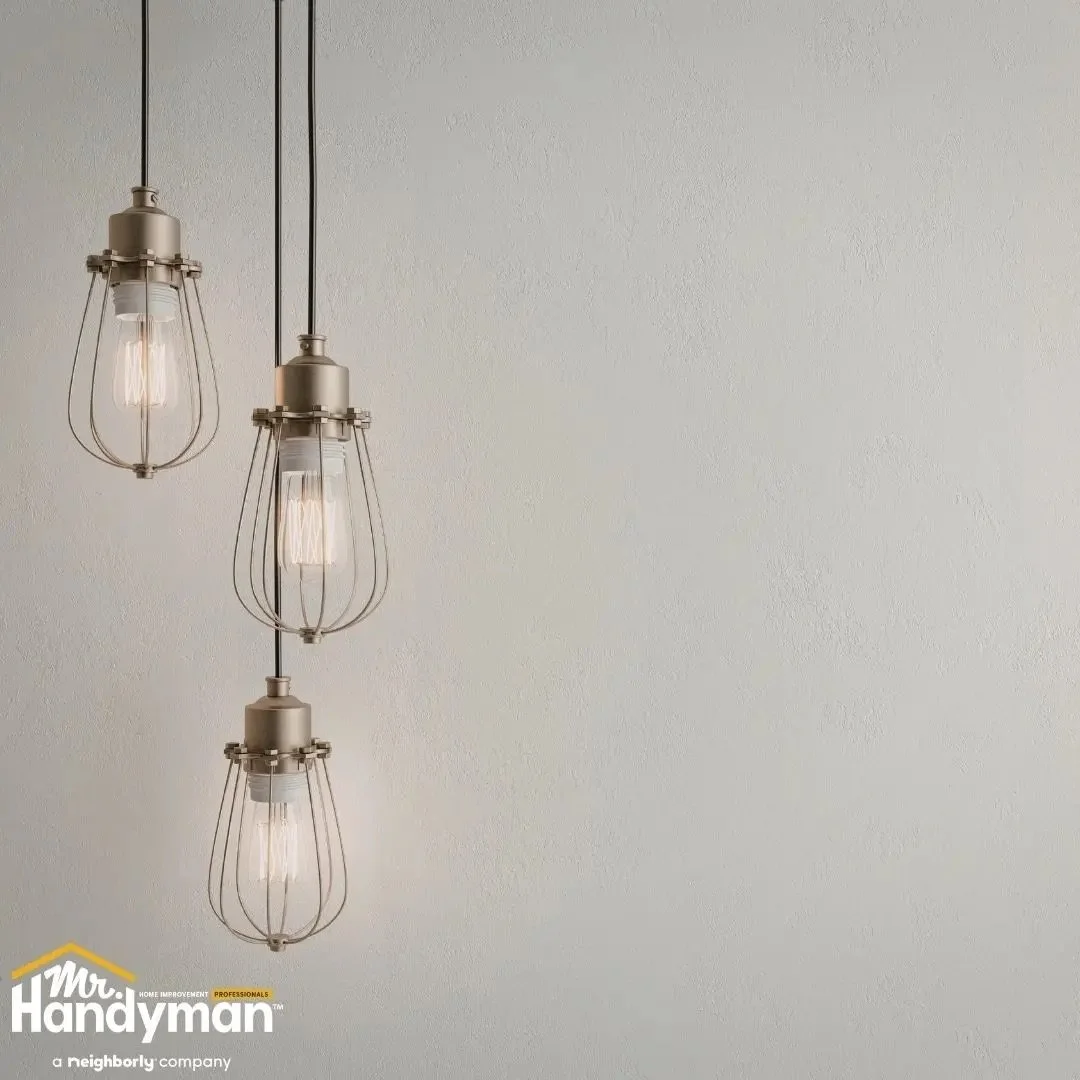 Electrician-style handyman installing a modern decorative ceiling light fixture for interior home lighting
