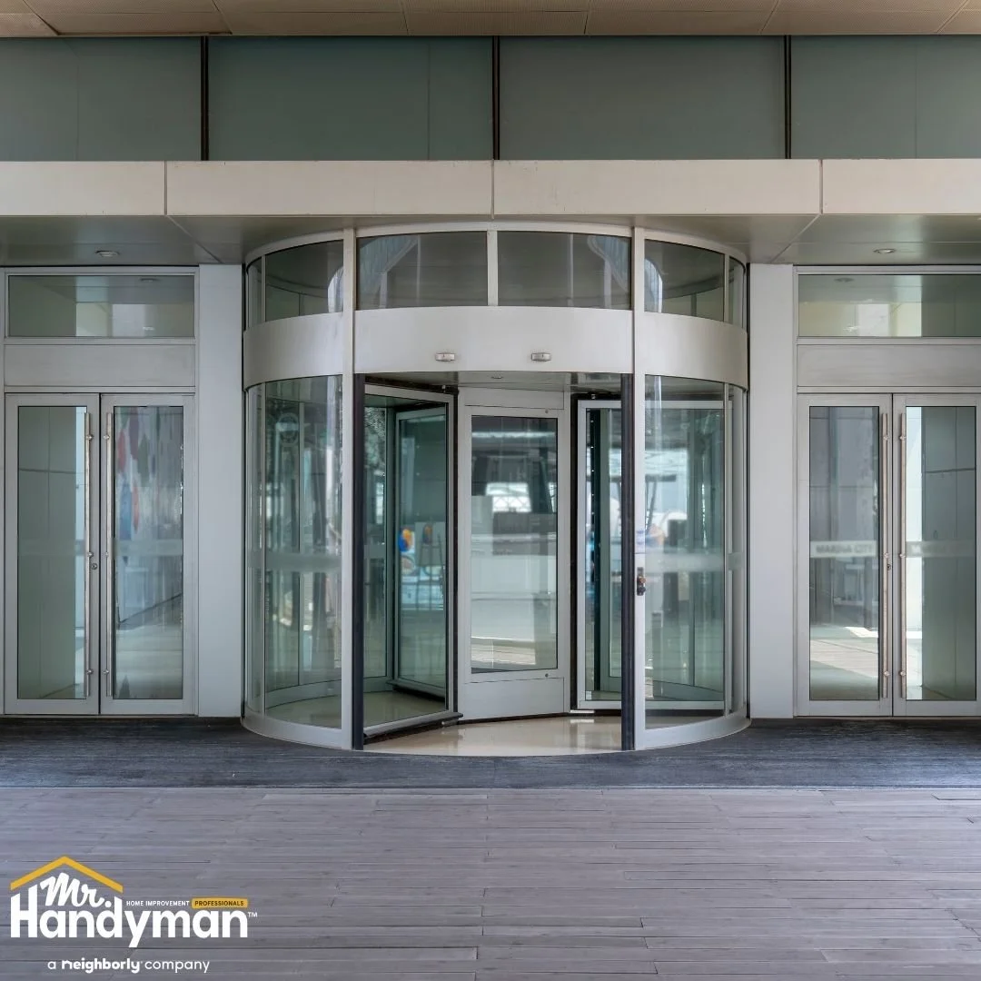 Glass revolving entrance door at a commercial building, professional door repair and maintenance by Mr. Handyman of Lehigh Valley
