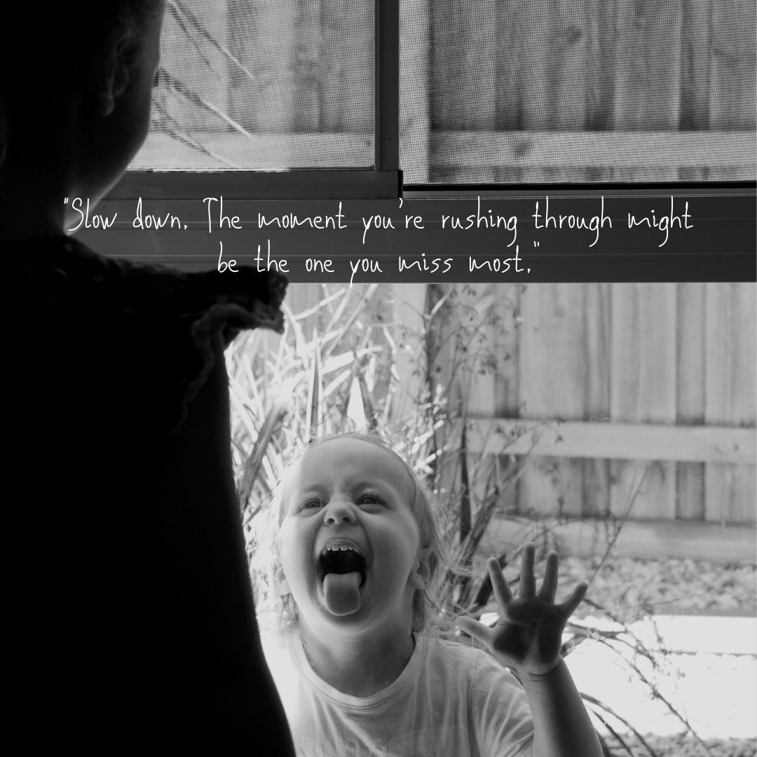 Black and white photography of a girl pulling a face at her sister. Text reads - Slow down. The moment you're rushing through might be the one you miss most."