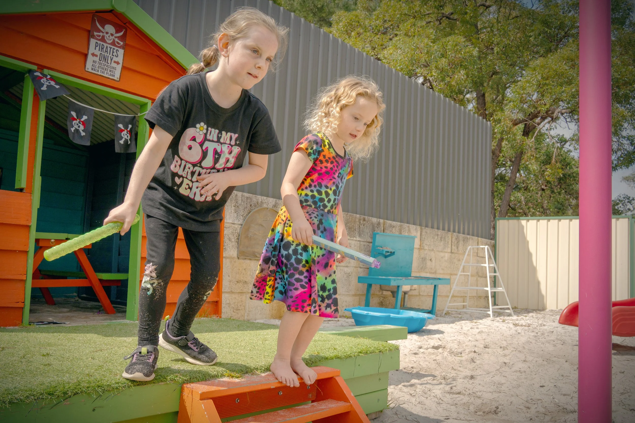 Two girls run and play at a birthday party in Pinjarra