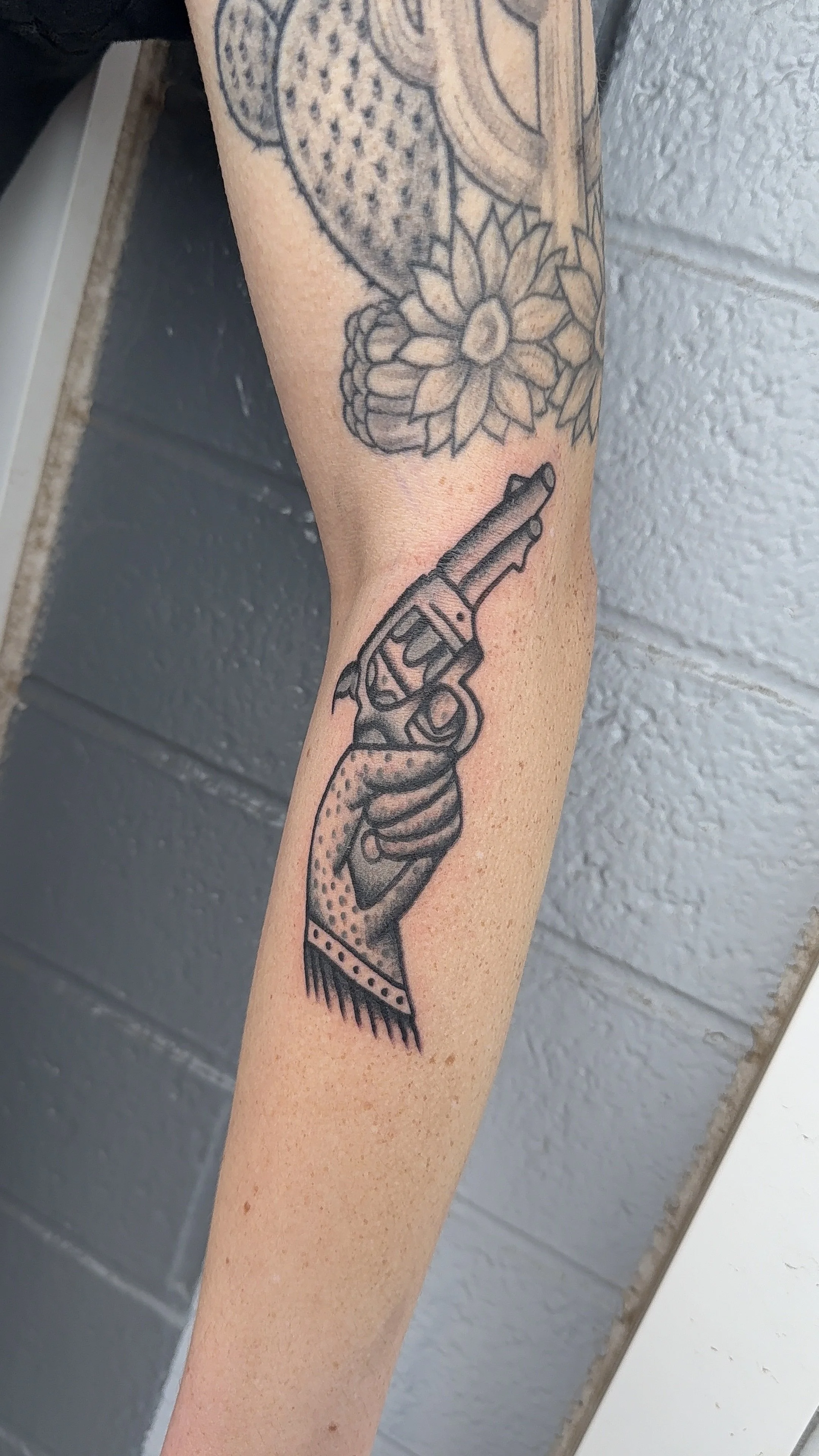 american traditional style black and grey cowgirl revolver tattoo