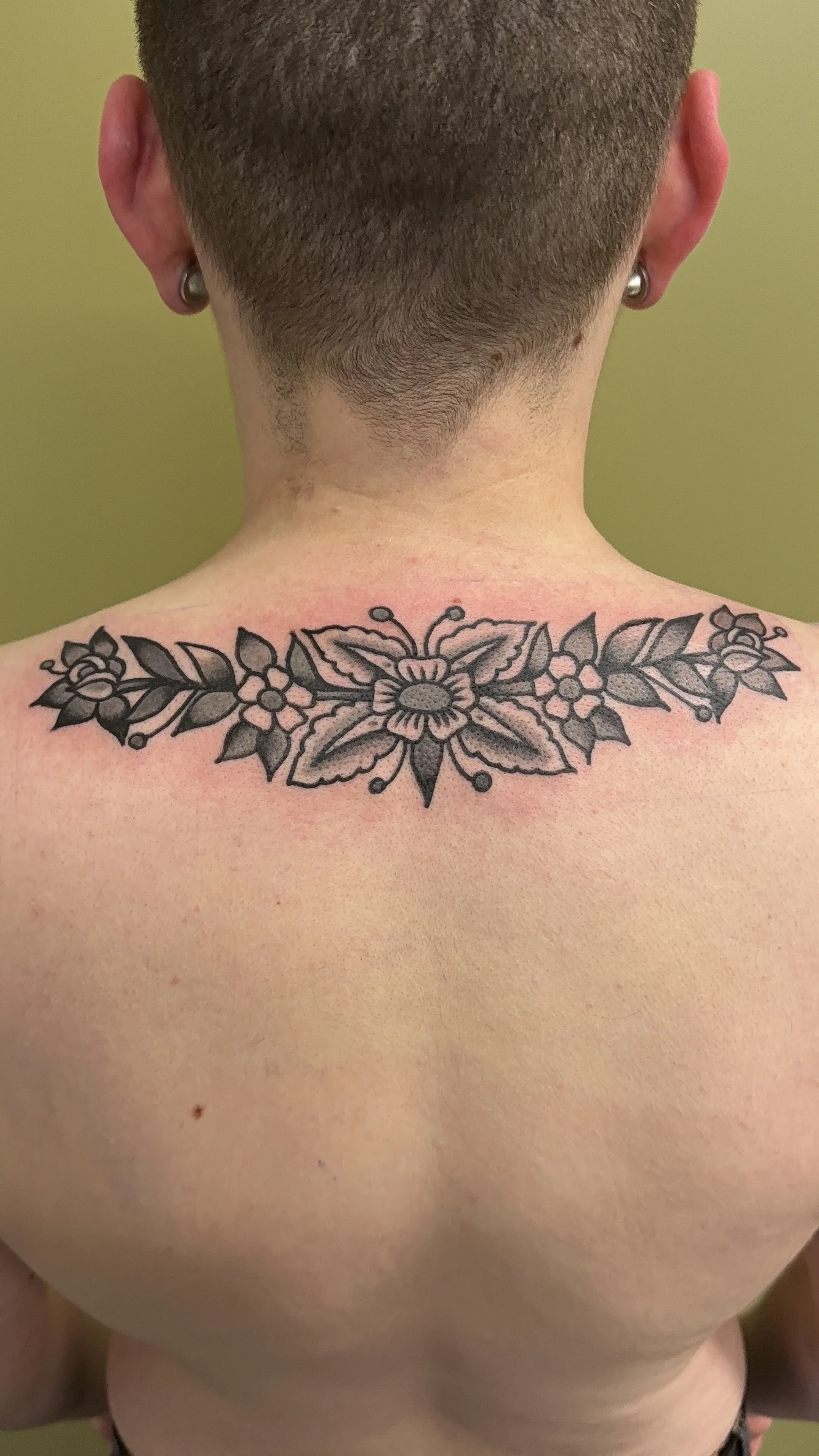 American Traditional Tattoo made in Portland, Oregon black and grey ornamental flowers on shoulders upper back tattoo