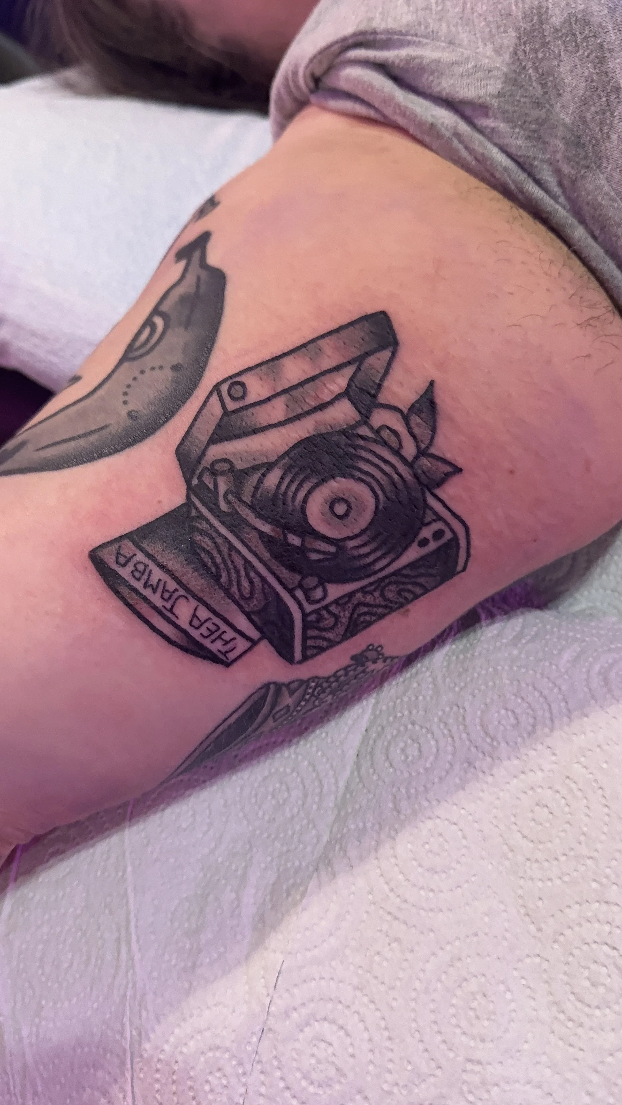 american traditional style black and grey record player tattoo