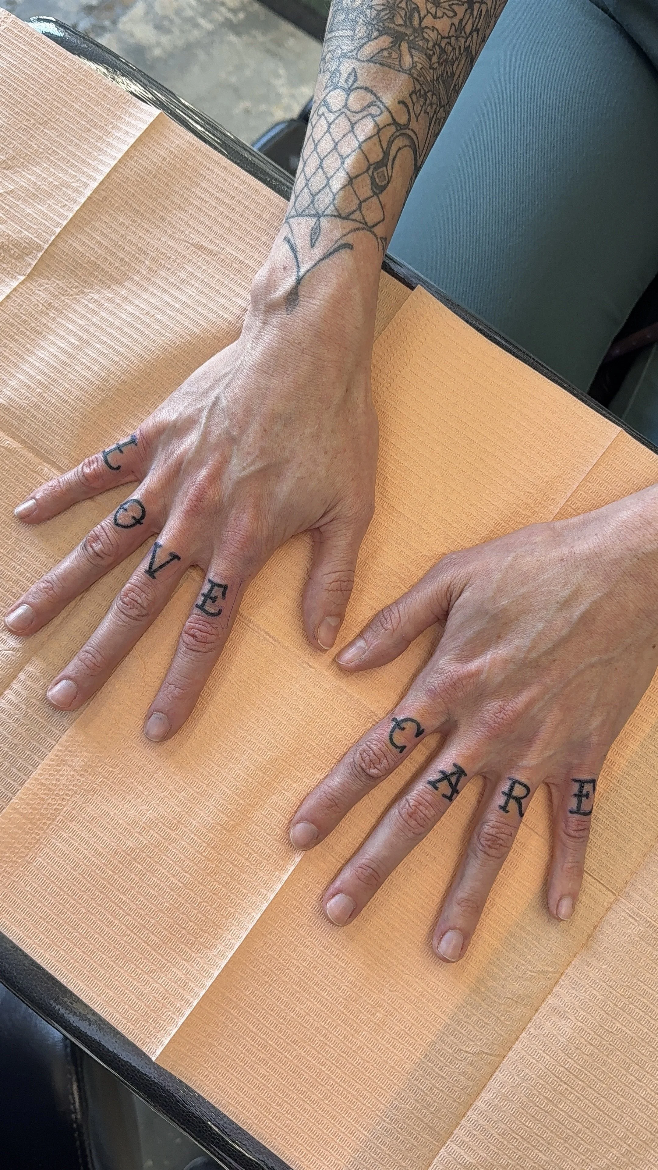 finger tattoos old fashioned lettering 